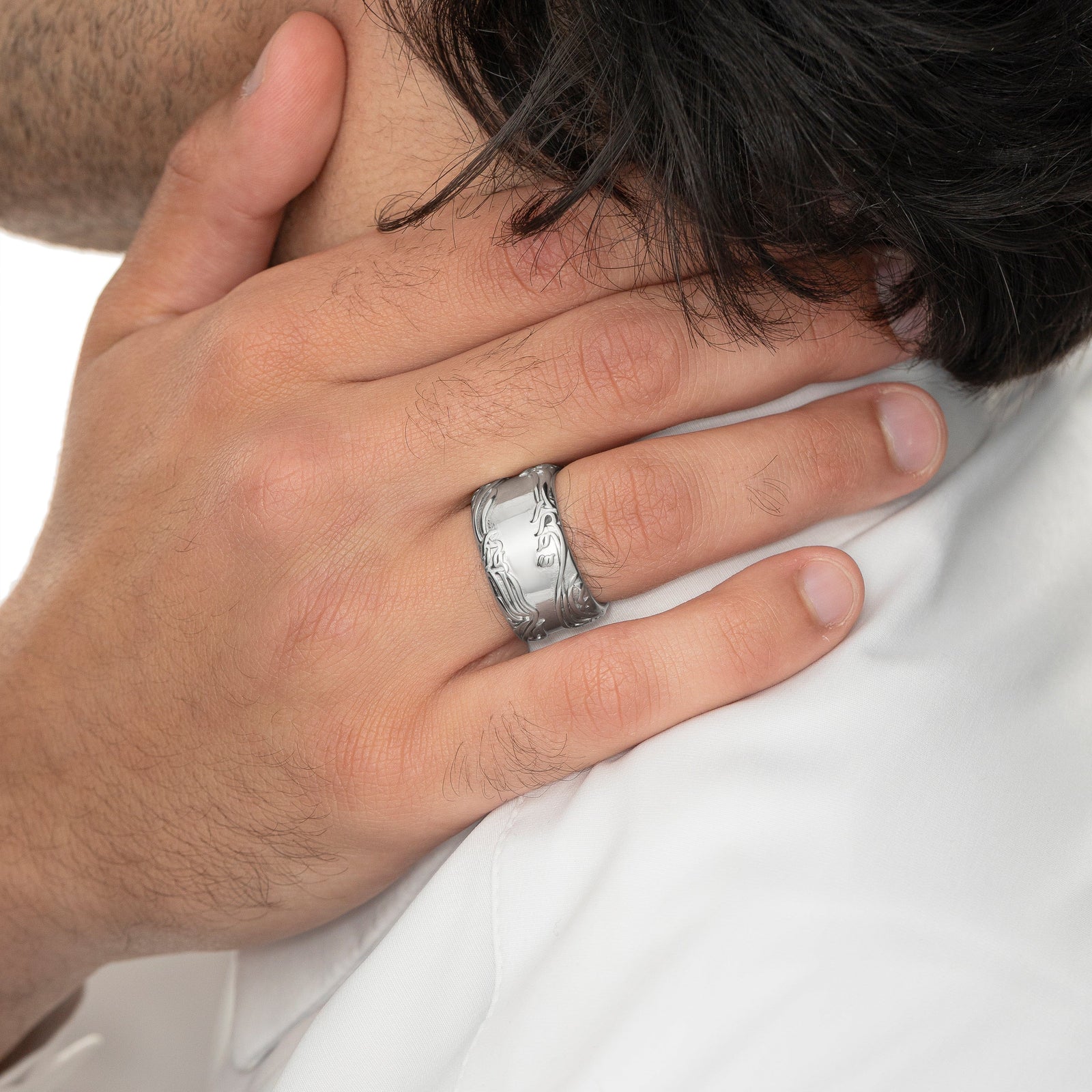 Close up of the model's right hand holding the side of their neck. The model is wearing the silver "The wound is where light enters you" Rumi Ring on their right ring finger.