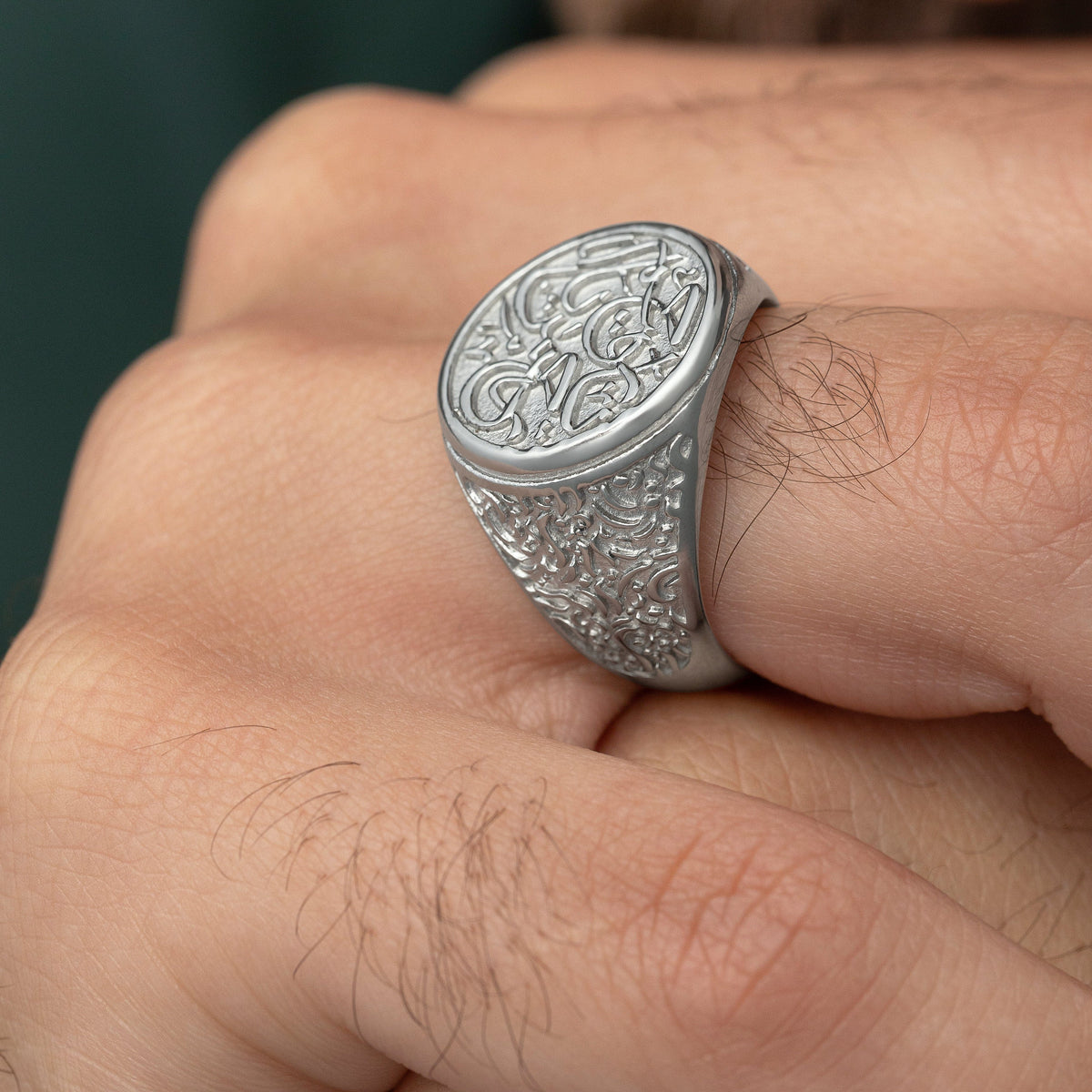 Close up of the silver "Ya Rahman, Ya Raheem" Ring worn by the model.
