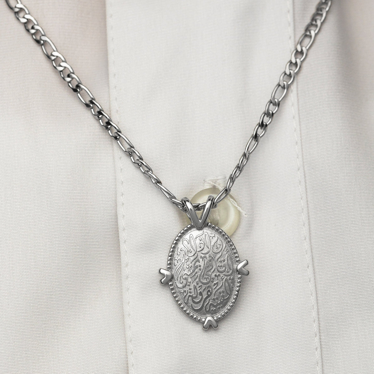 Close up of the Walk to Me, and I'll run to you Medallion Necklace on a white background.