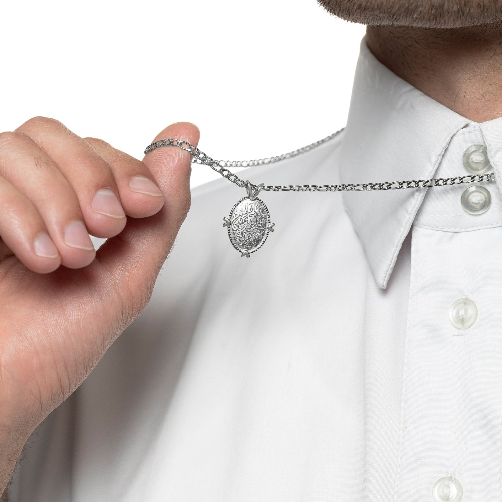 Model holds the chain of the silver Walk to Me, and I'll run to you Medallion Necklace showing the design of the pendant.
