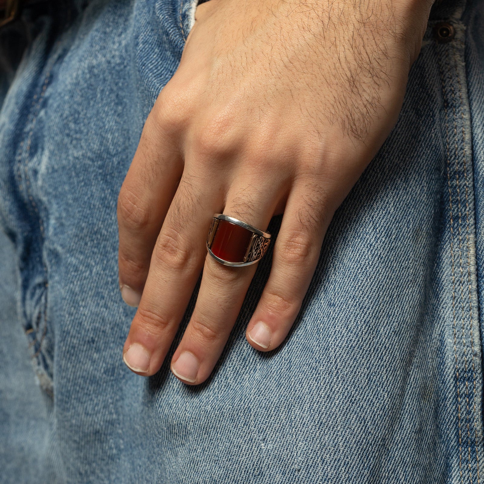 Photo of the model's left hand as they wear the Shahada Agate Sterling Silver Ring on their ring finger.