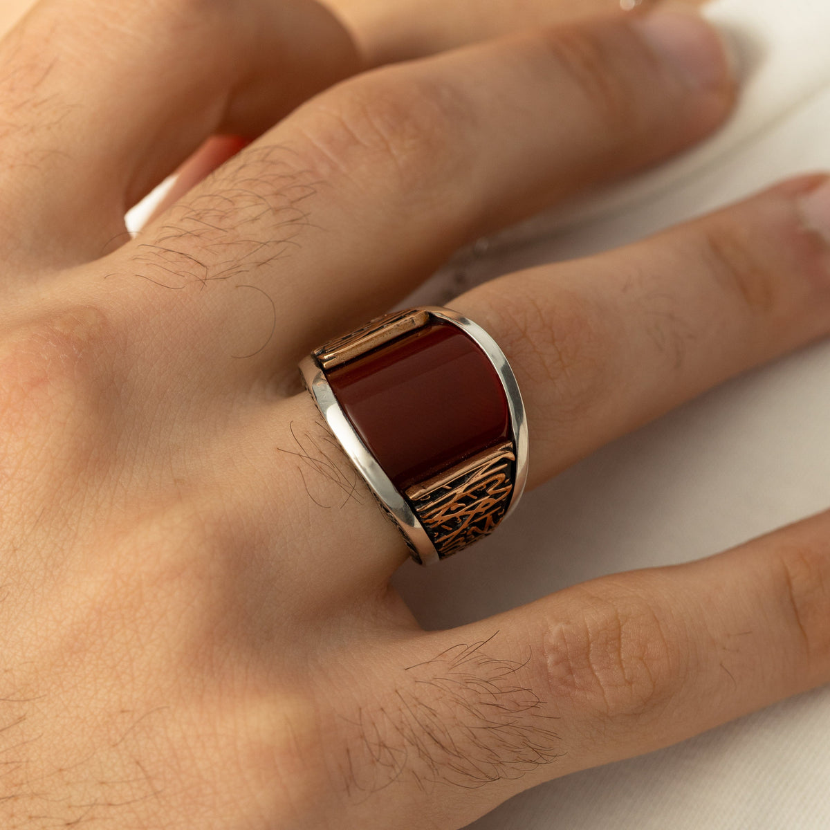 Close up of the Shahada Agate Sterling Silver Ring as worn by the model on their right ring finger.
