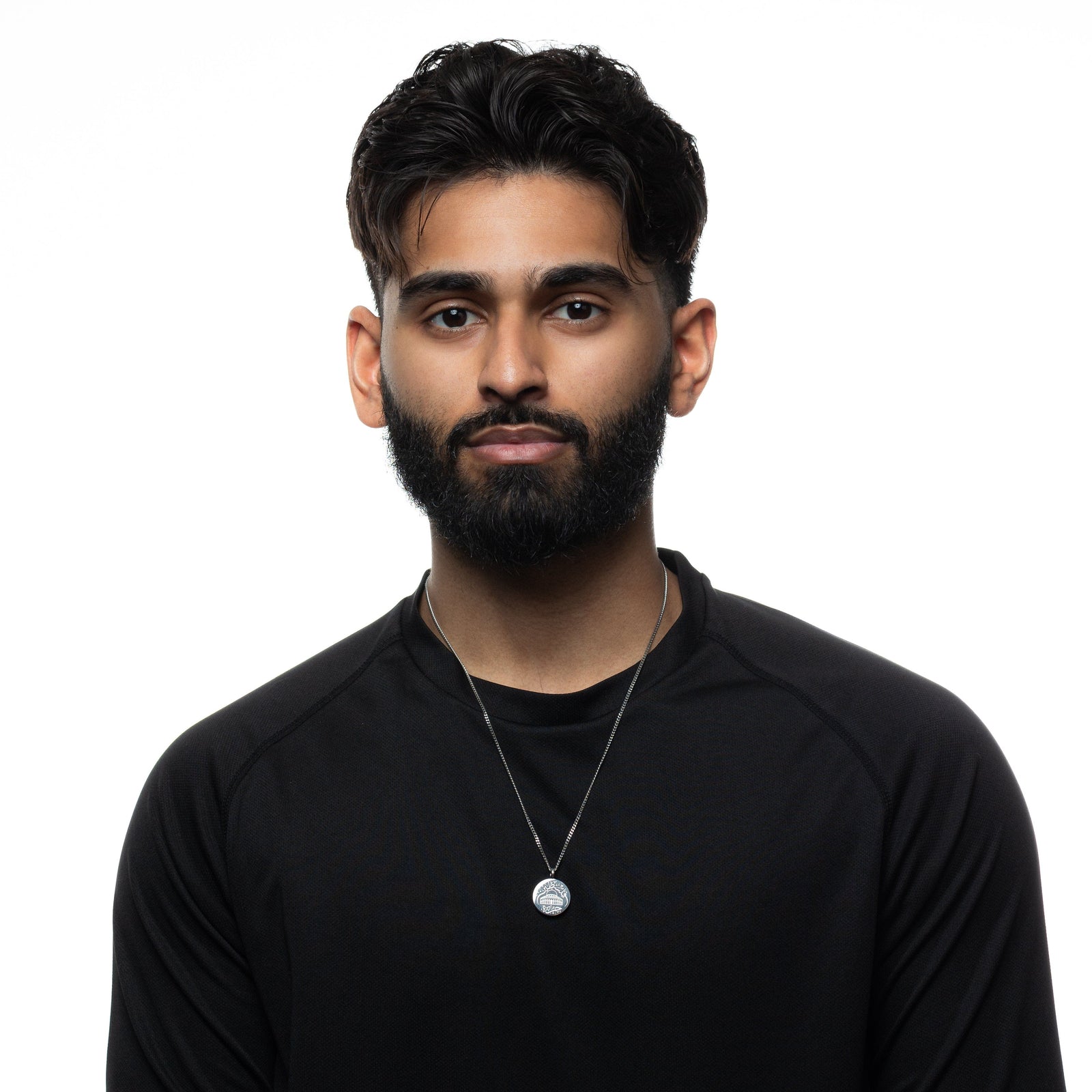 Man wearing a black shirt and silver Al-Aqsa ‘Free Palestine’ Necklace on a white background.