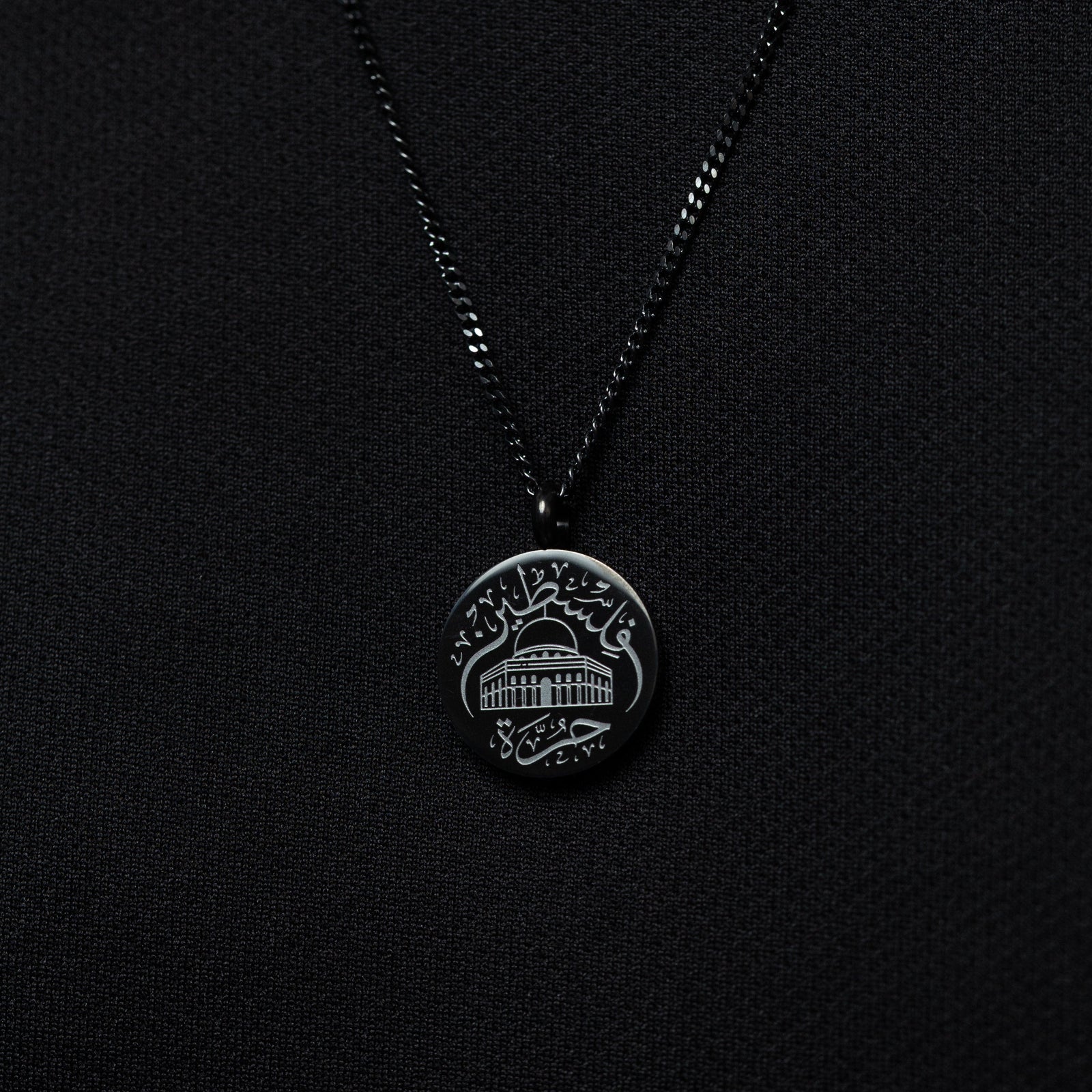 Black Al-Aqsa ‘Free Palestine’ Necklace on a black fabric