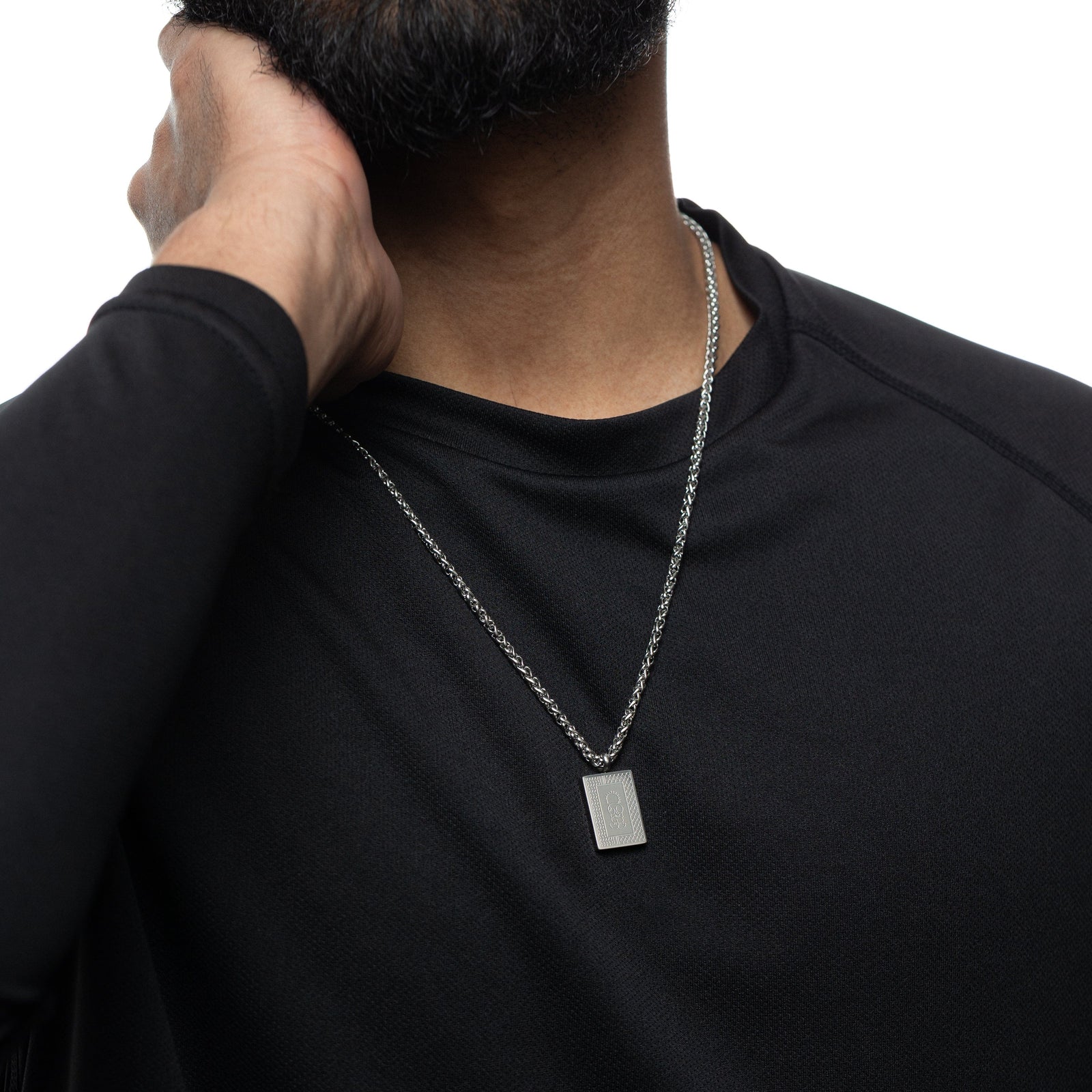 Man wearing a black shirt with a silver Handala Necklace