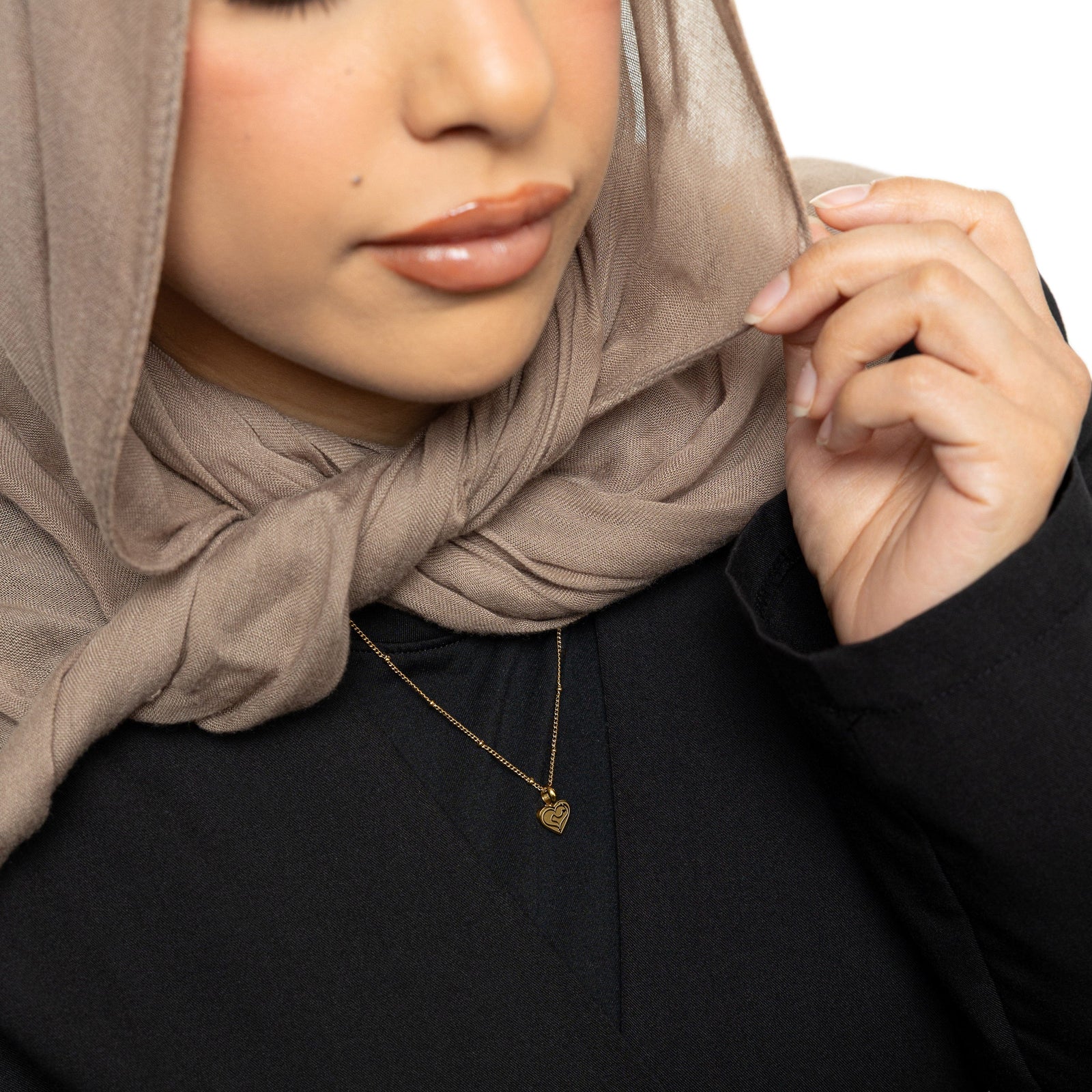The gold Mother Love Necklace as worn by the model.