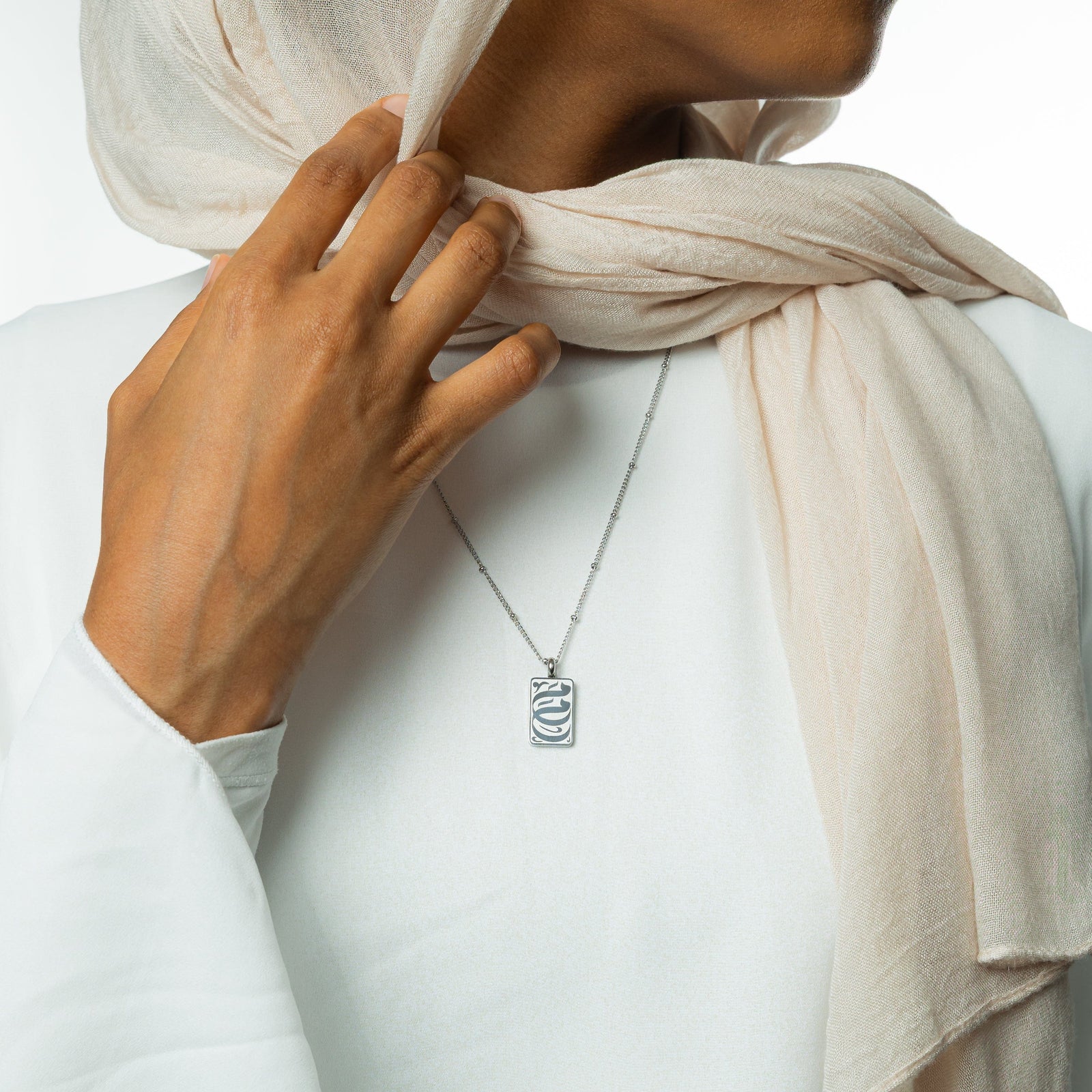The silver My Mother Tag Necklace as worn by the model.