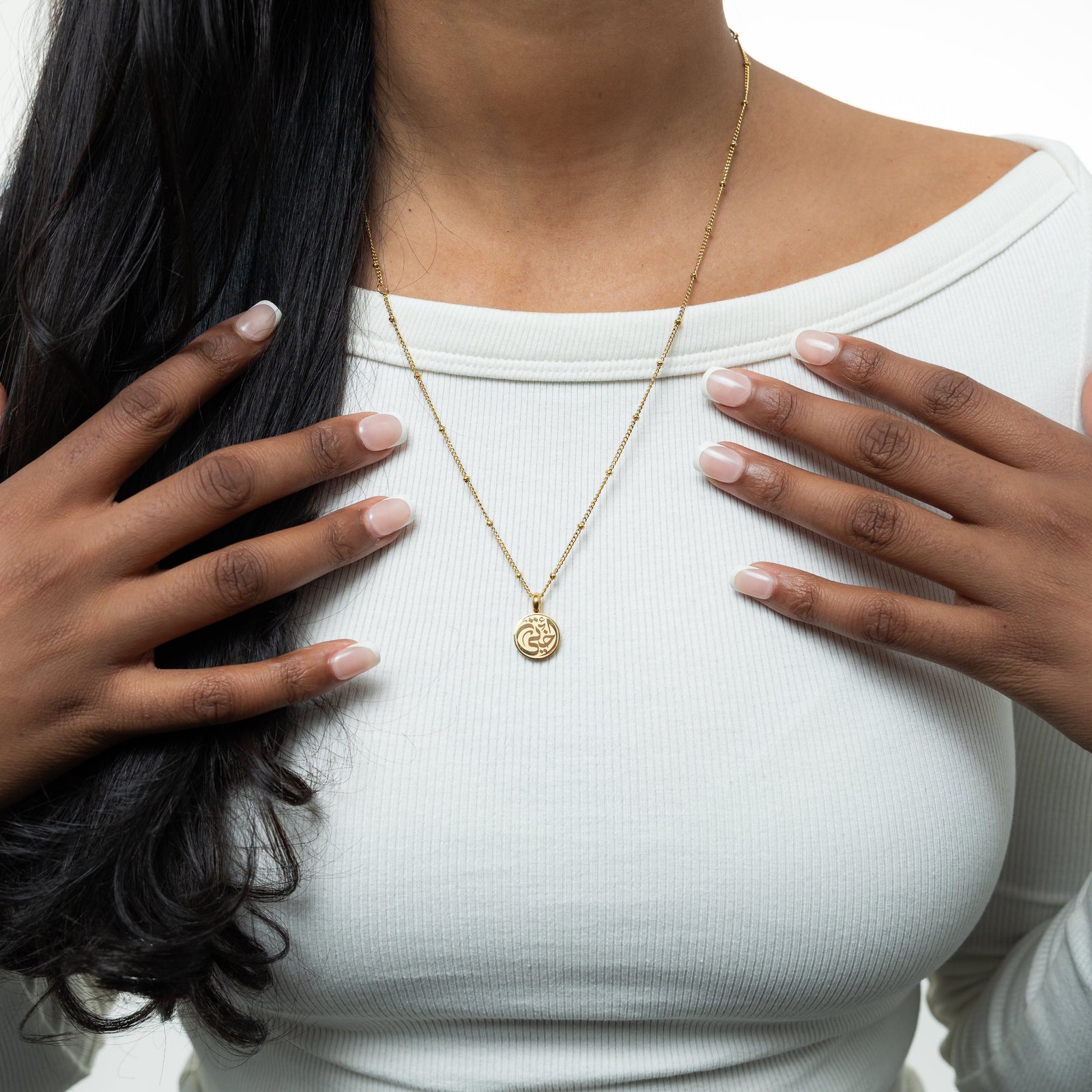 The gold My Sister Necklace as worn by the model.