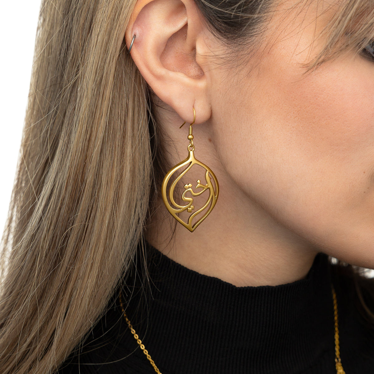Close up of the earring worn by the model.