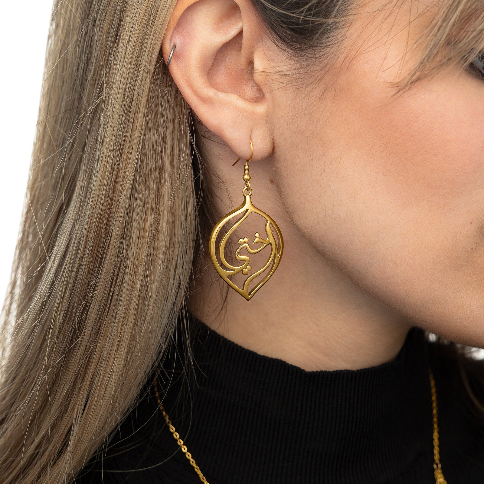Close up of the earring worn by the model.