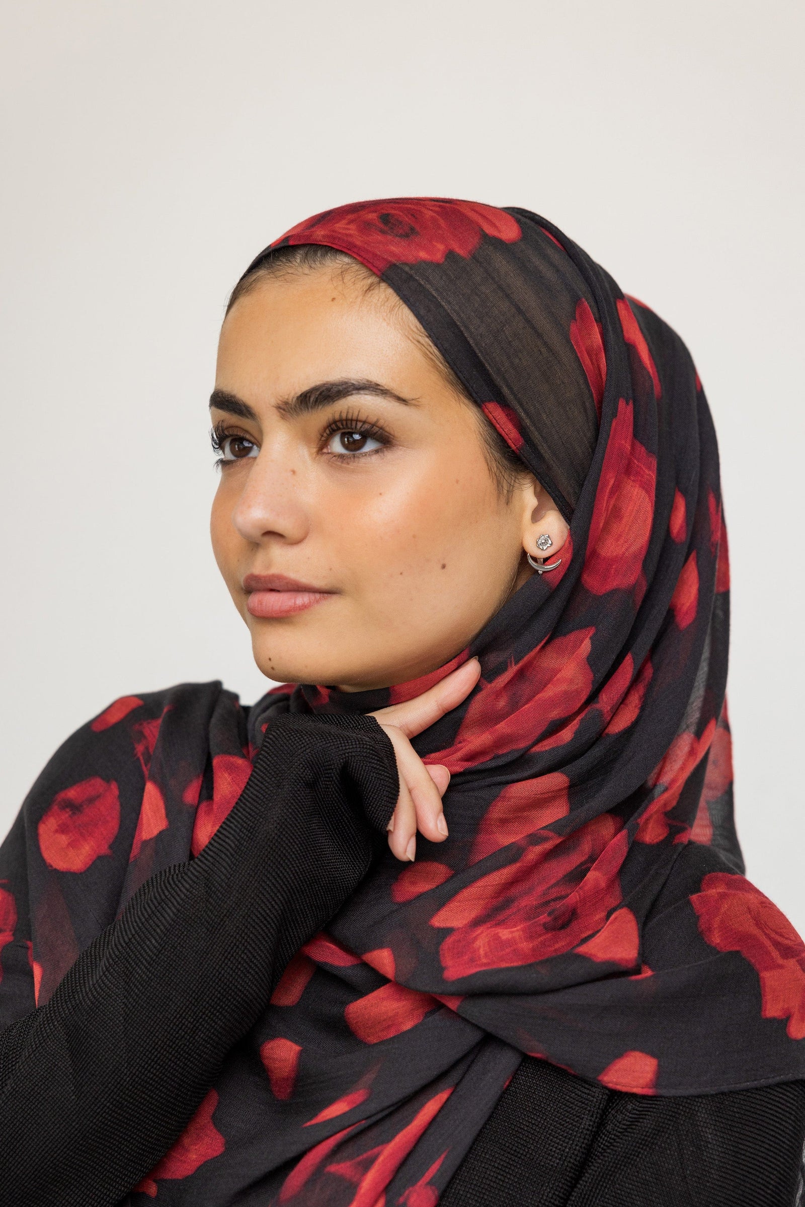 Photo of the model wearing the silver Damask Rose & Crescent Jacket Earrings | VELA x Nominal on their left ear.