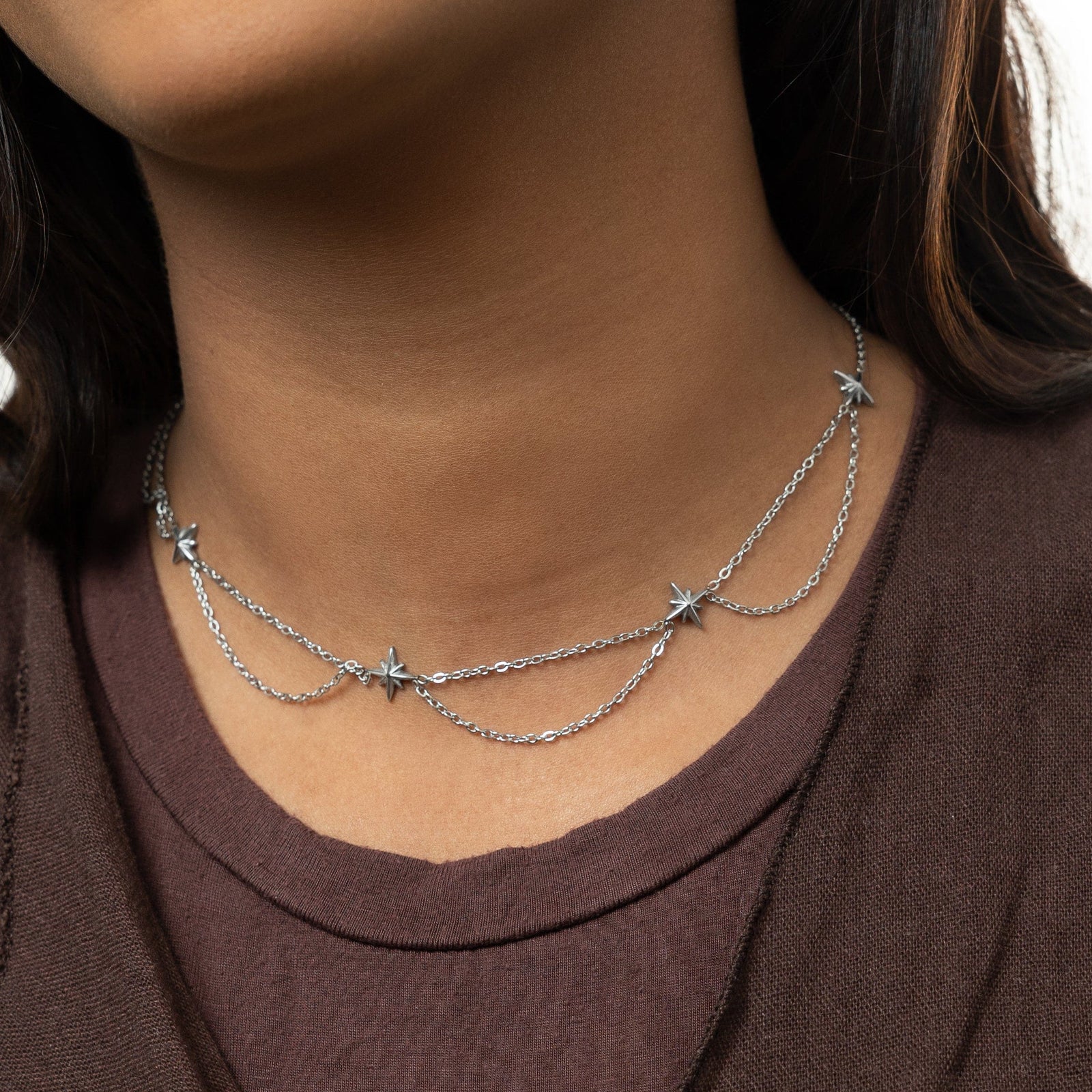 Close up of the silver North Star Choker as worn by the model.