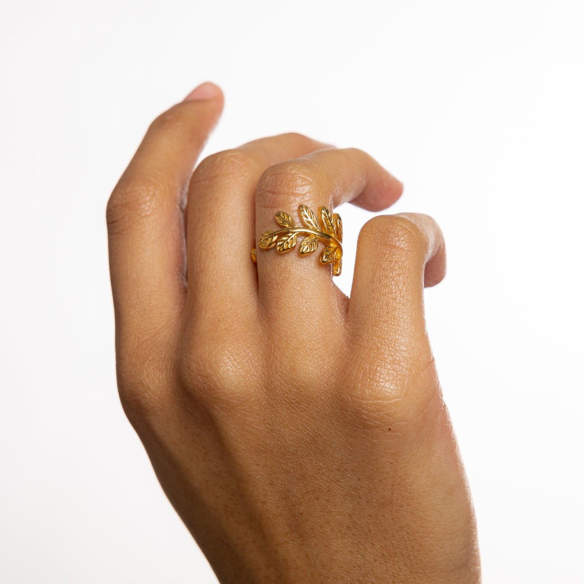 Hand wearing the gold Olive Branch Ring