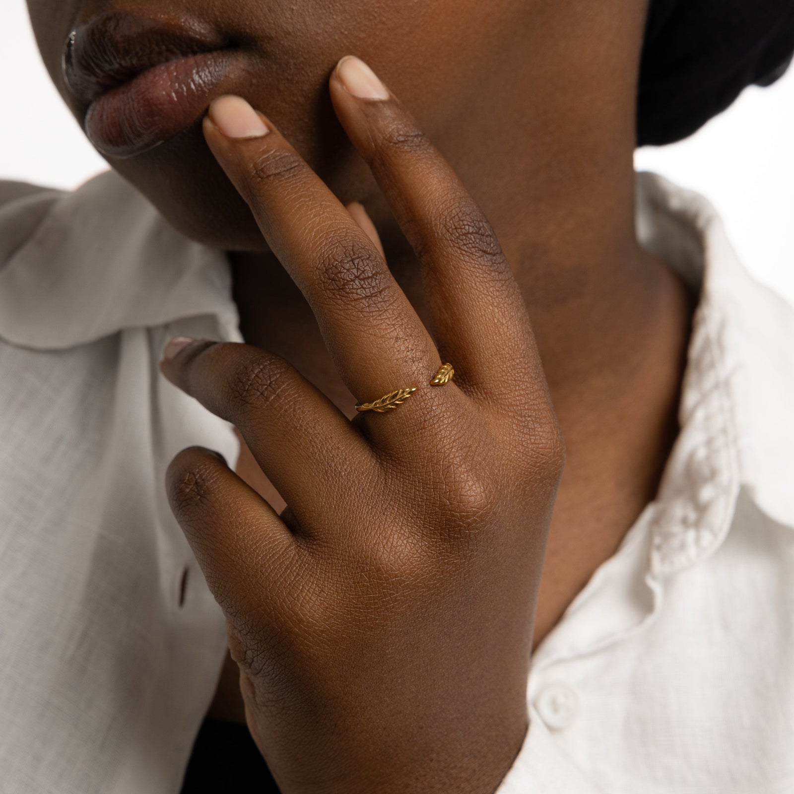 The gold Palestine Olive leaf ring V2 worn on a model's finger, showcasing the olive leaf design.
