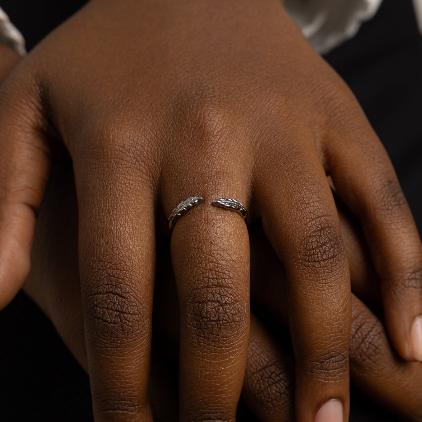 The silver Palestine Olive leaf ring V2 worn on a model's finger, showcasing the olive leaf design.