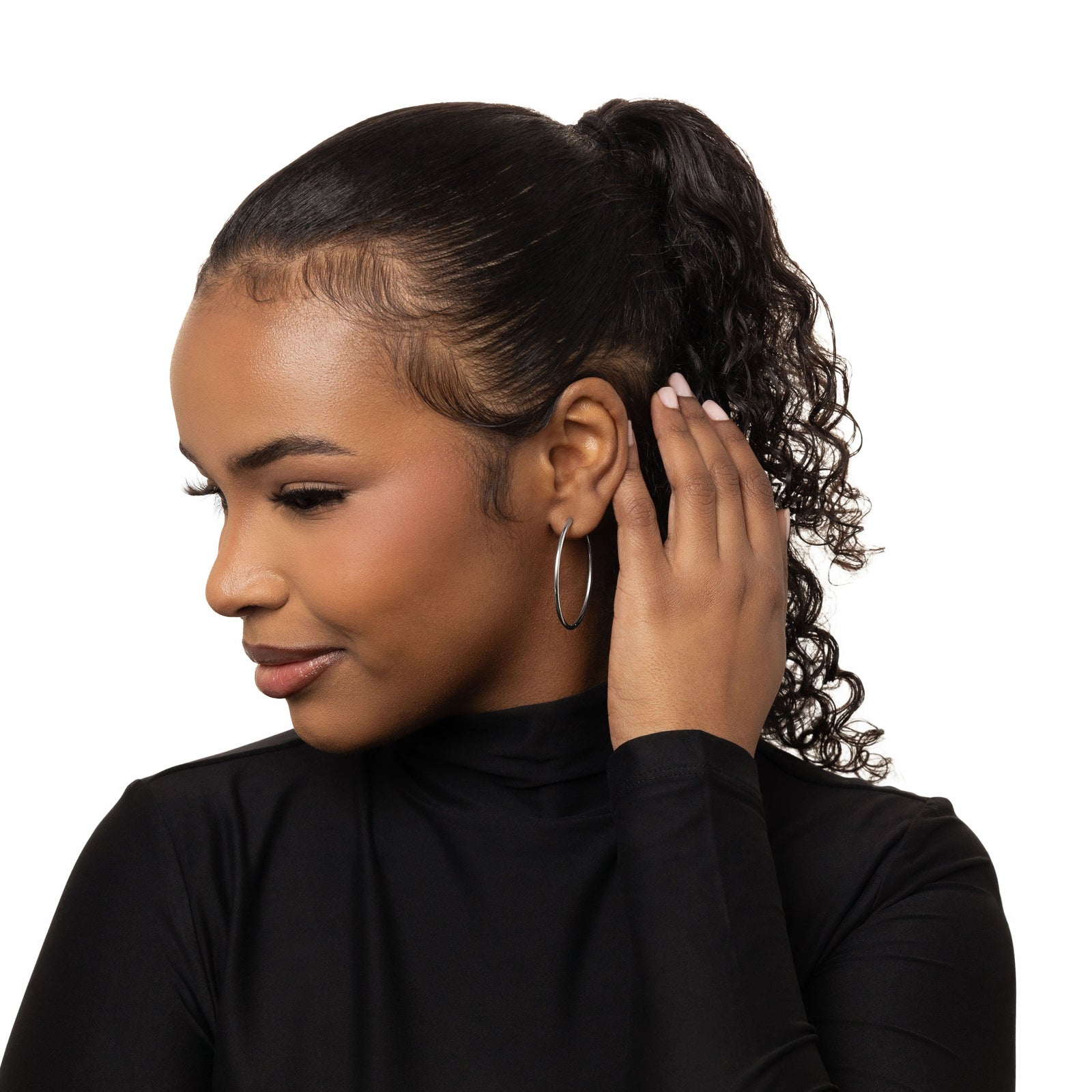 Photo of the model holding their hair behind their left ear. The model is wearing the silver Oversized Essential Hoops | 40mm on their left ear.