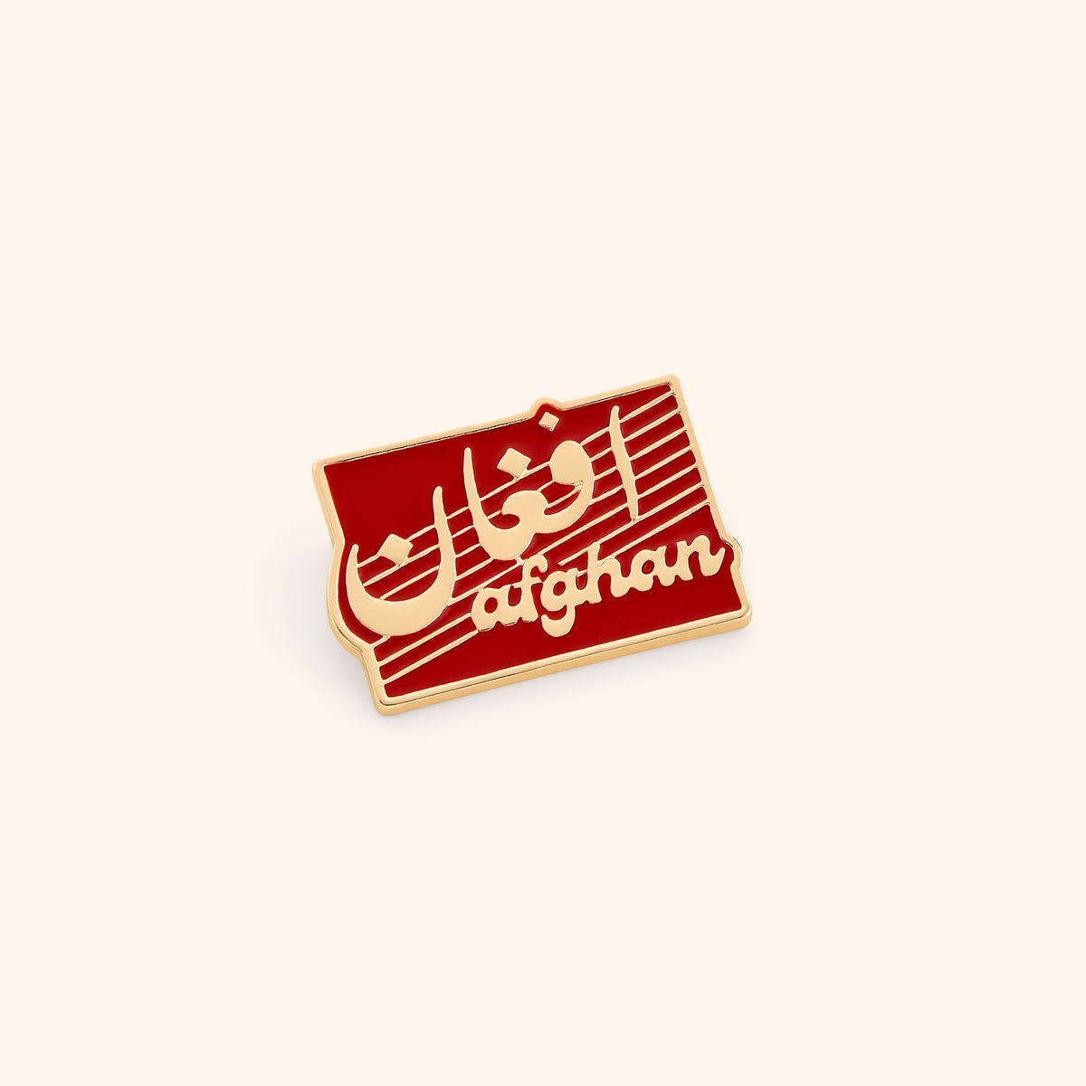 18k gold-plated Afghan Pin set on a light background. 