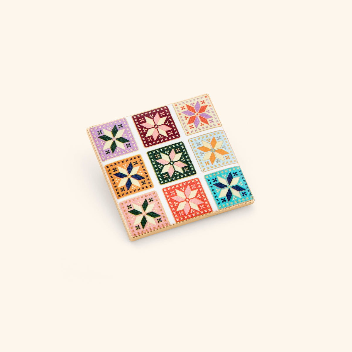 18k gold-plated Tatreez Grid Pin set on a light background. 