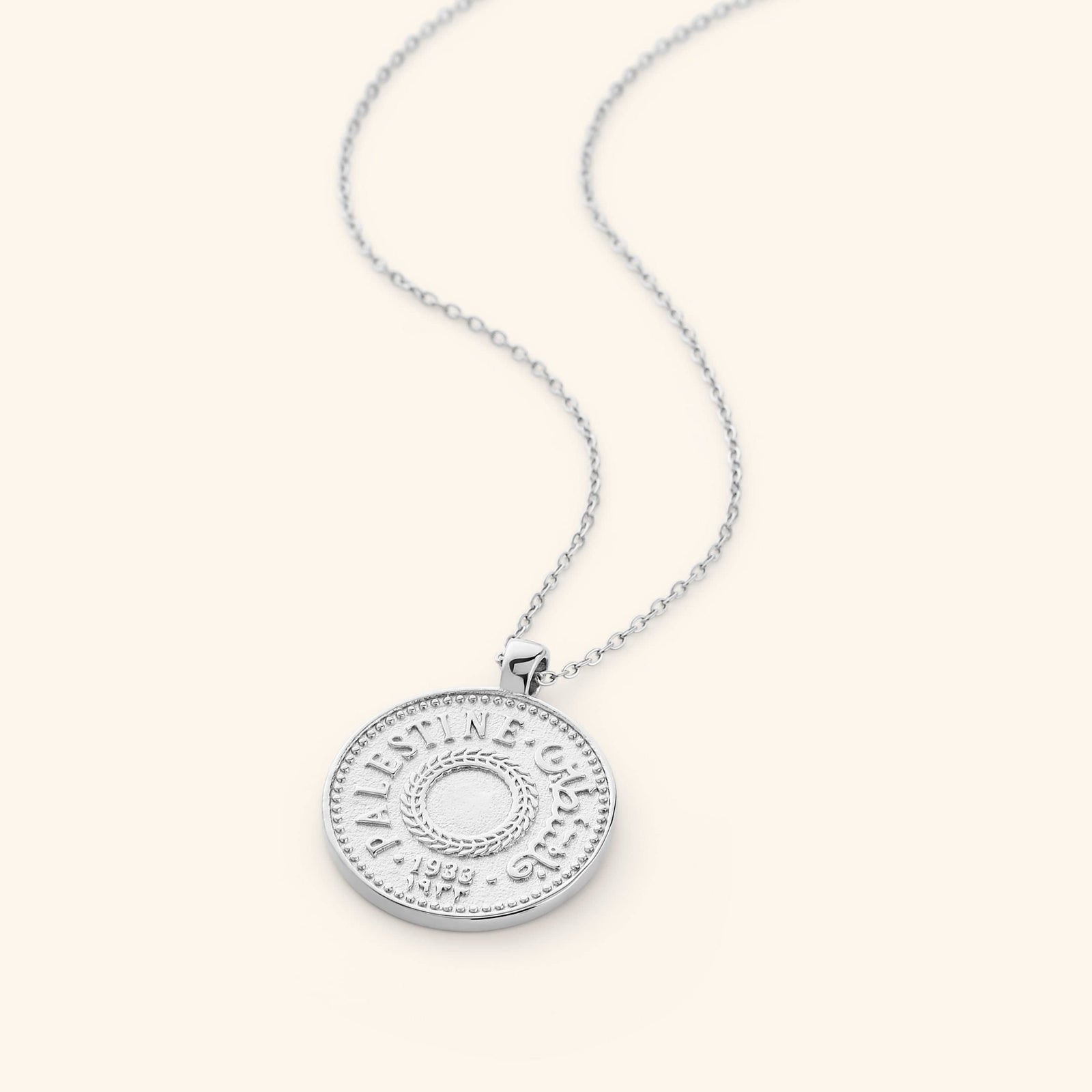 Flat lay of the silver Palestine Coin Necklace