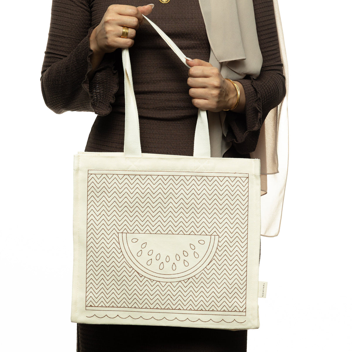 Photo of a model holding the Patterned Palestine Watermelon Tote by its strap.