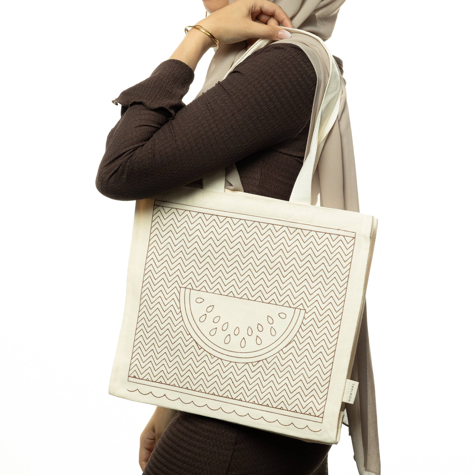 Photo of the model wearing the Patterned Palestine Watermelon Tote on their left shoulder.