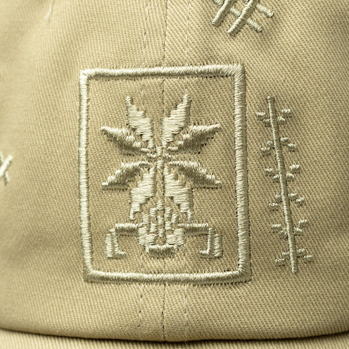 Close up of the Tatreez embroidery design of the beige cap.