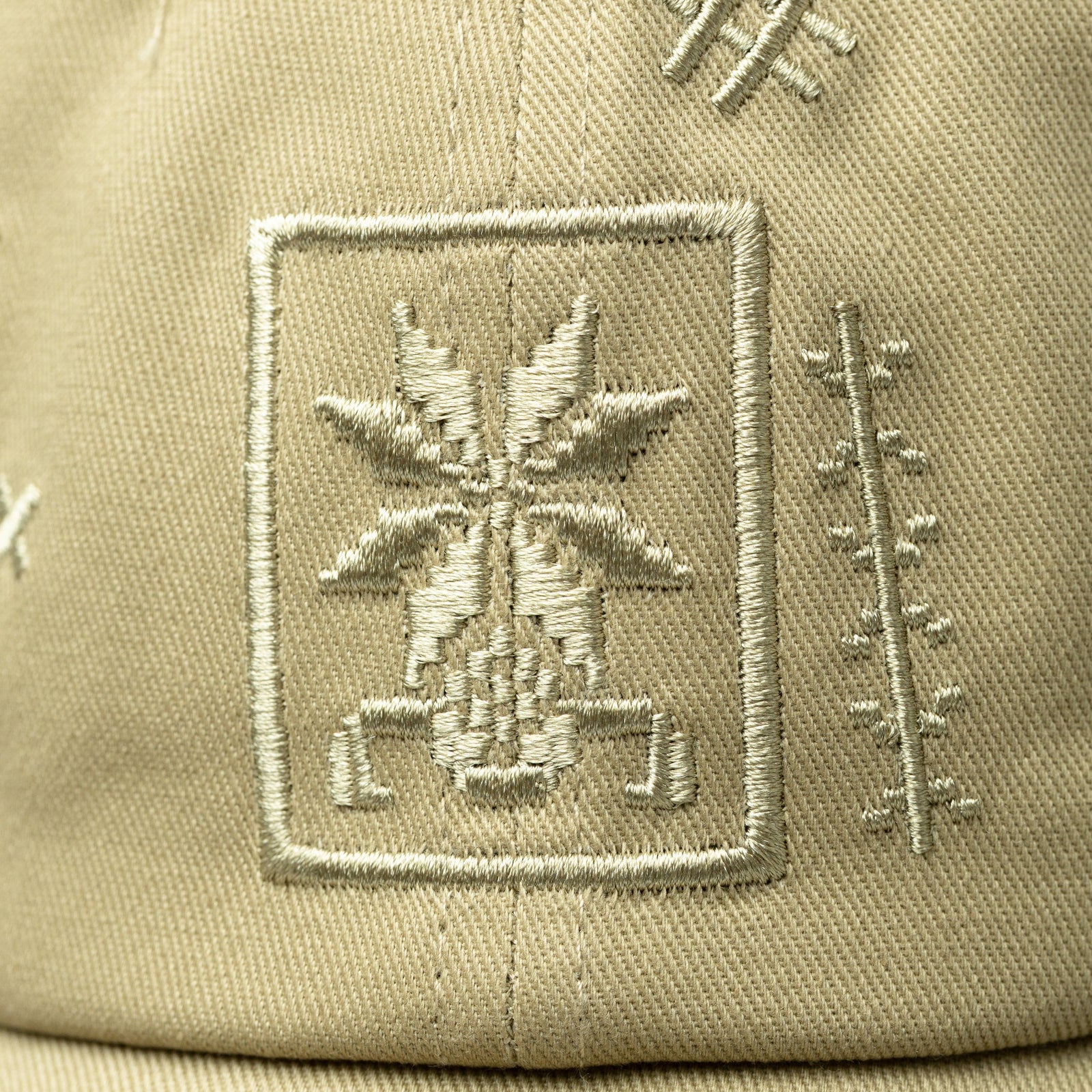 Close up of the Tatreez embroidery design of the beige cap.