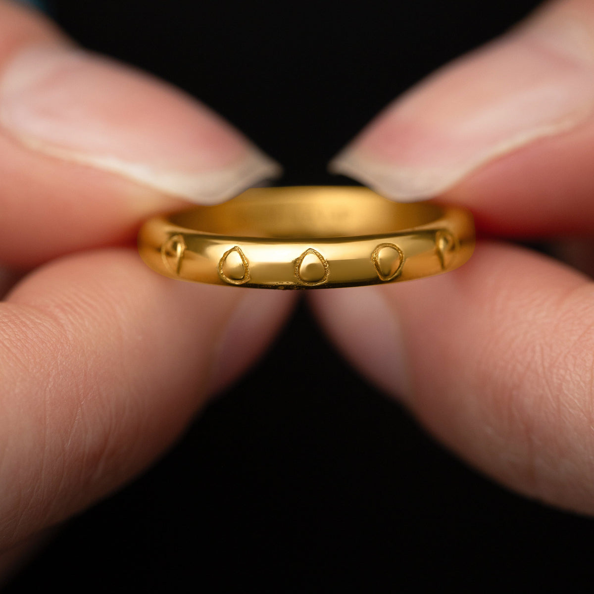 Model holds the gold Palestinian Watermelon Seed Ring to show its design. 
