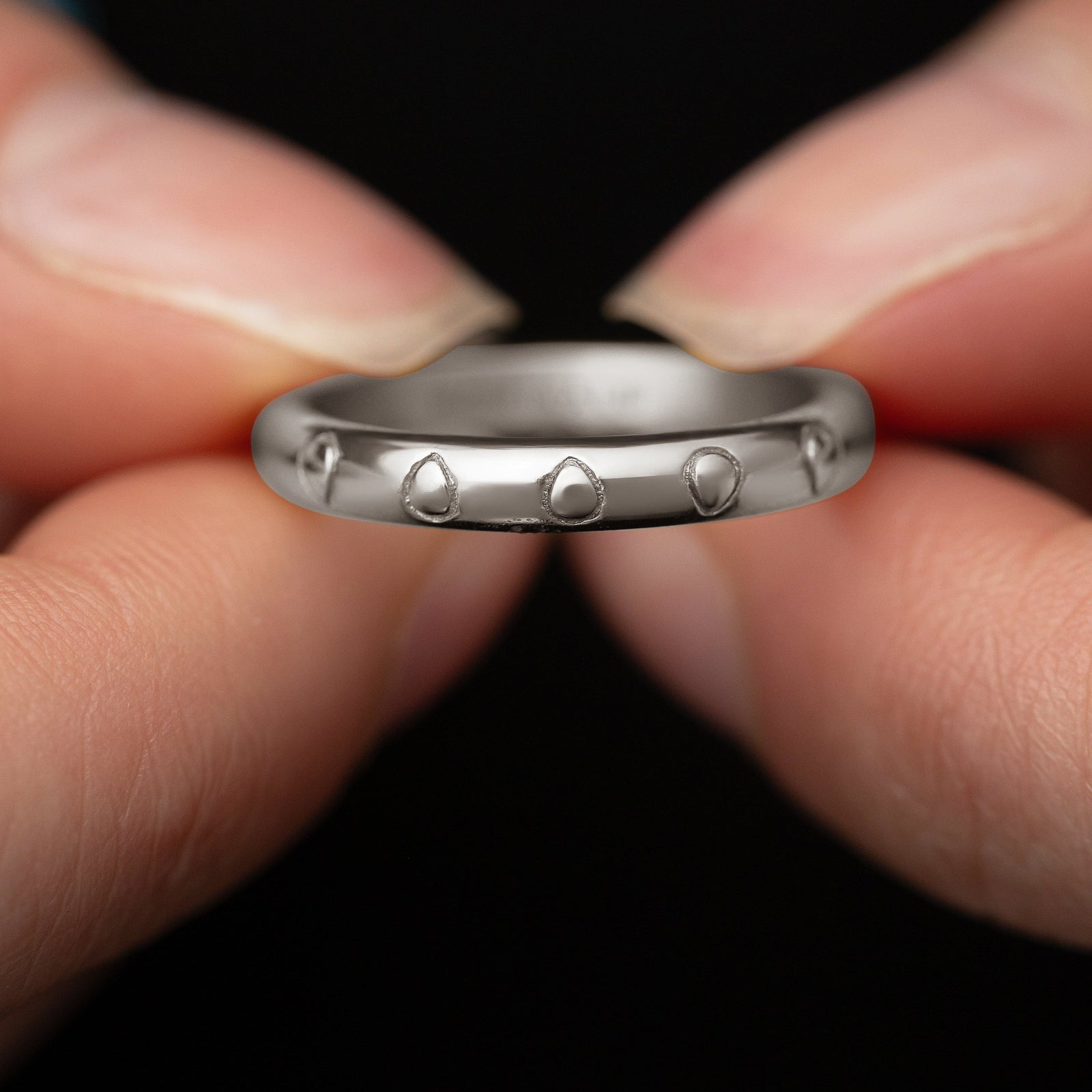 Model holds the silver Palestinian Watermelon Seed Ring to show its design. 