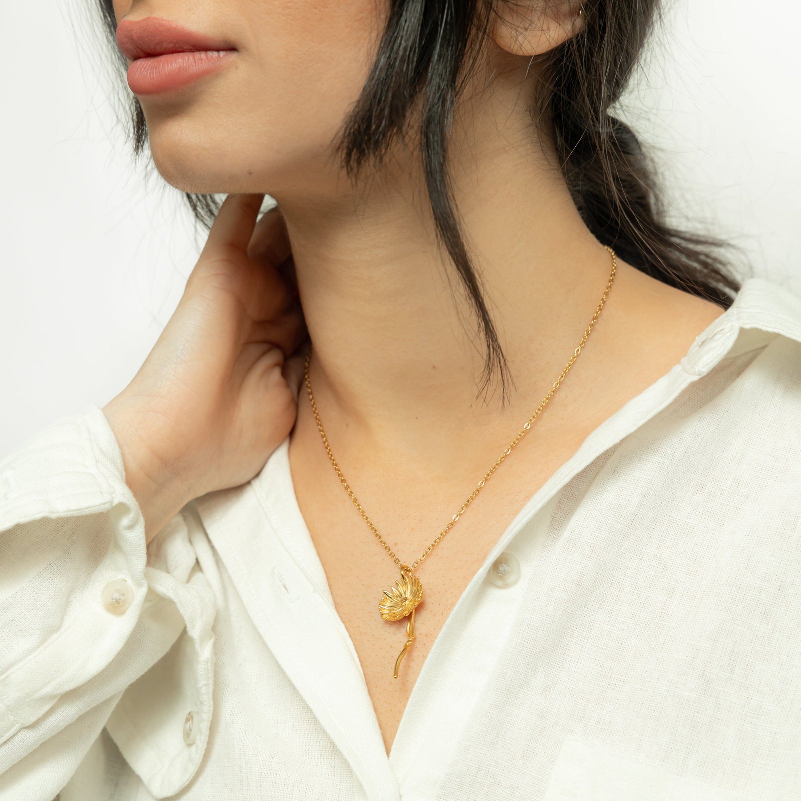Photo of the model wearing the gold Patience' Aster Necklace.