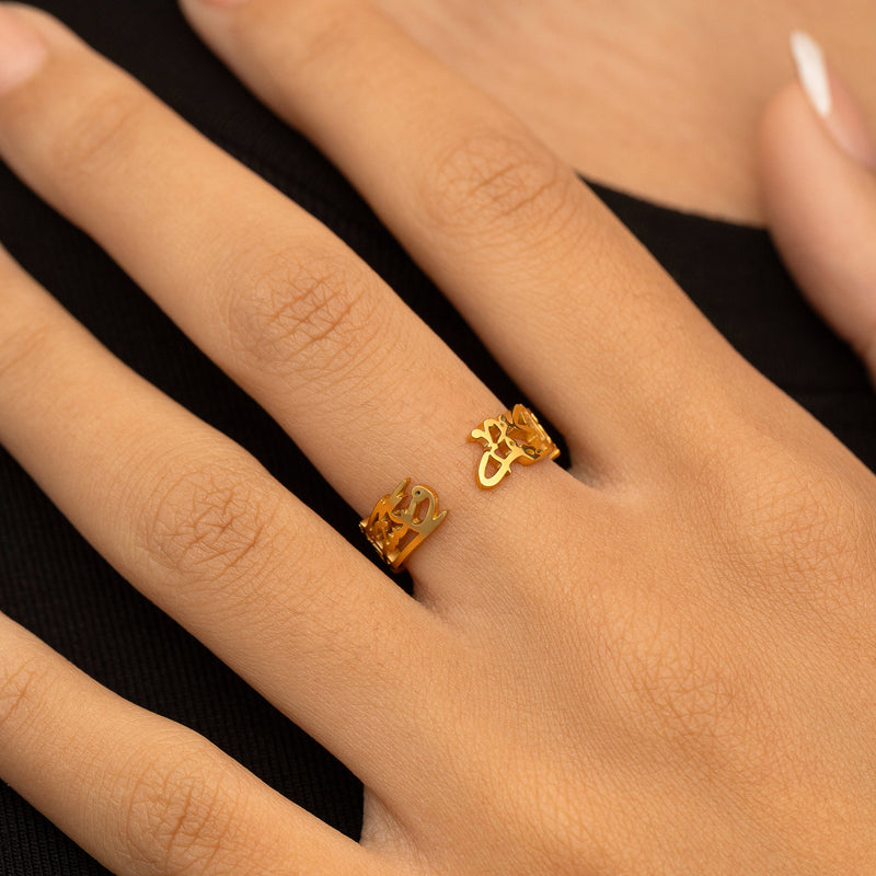 A woman wearing the "Perhaps you dislike something which is good for you" Calligraphy Ring in gold pimage_ with the open ends of the design facing up.
