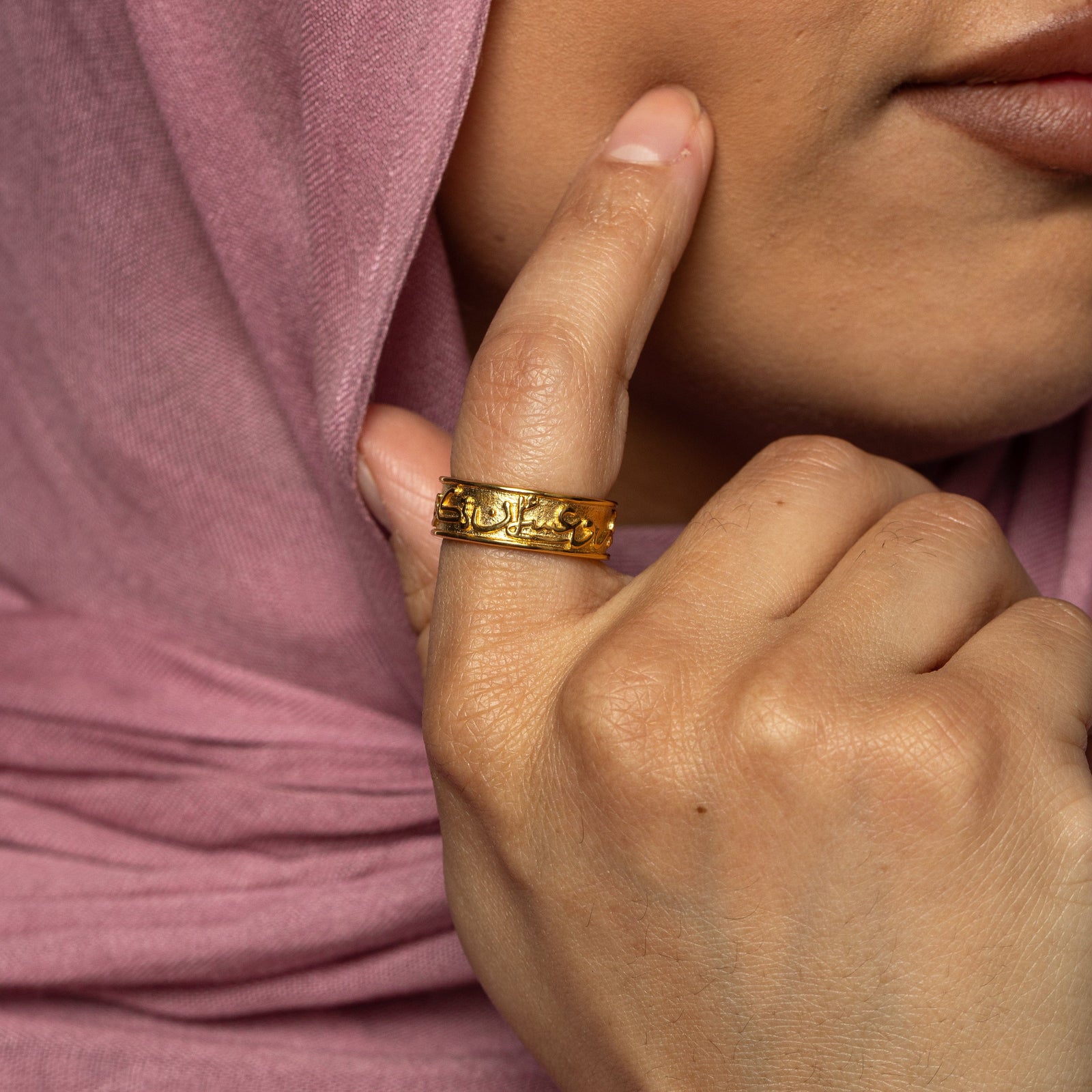 Model touching their cheek with their right index finger. On the same finger, they are wearing the gold "Perhaps you dislike what is good for you" Ring.