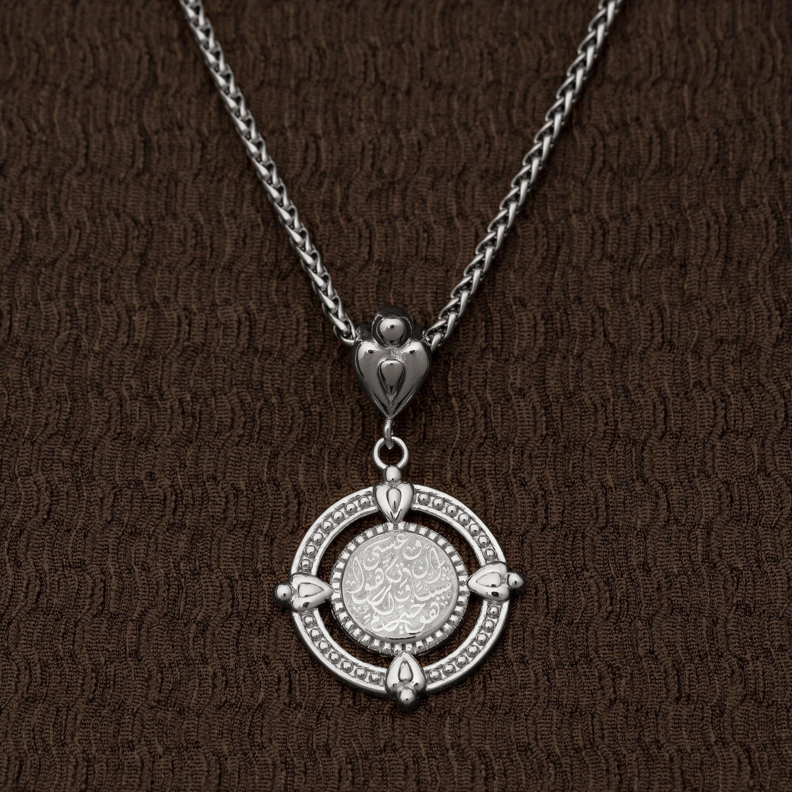 Close-up of the silver “Perhaps you dislike what's good for you” Coin Necklace