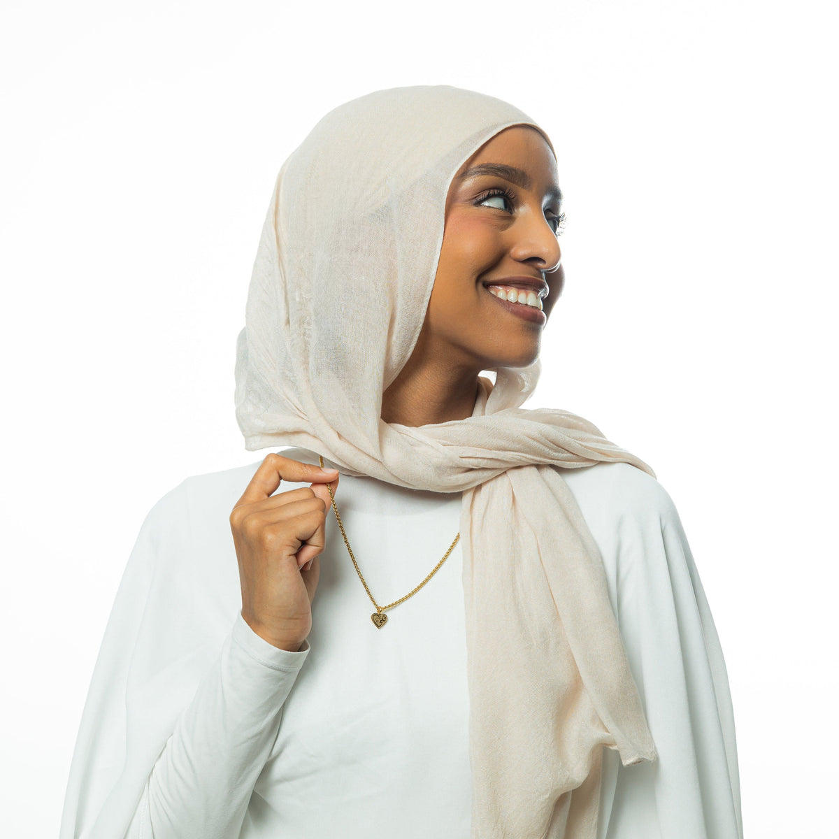 Photo of the model holding the gold chain of the "Piece of Me" Daughter Necklace they are wearing.