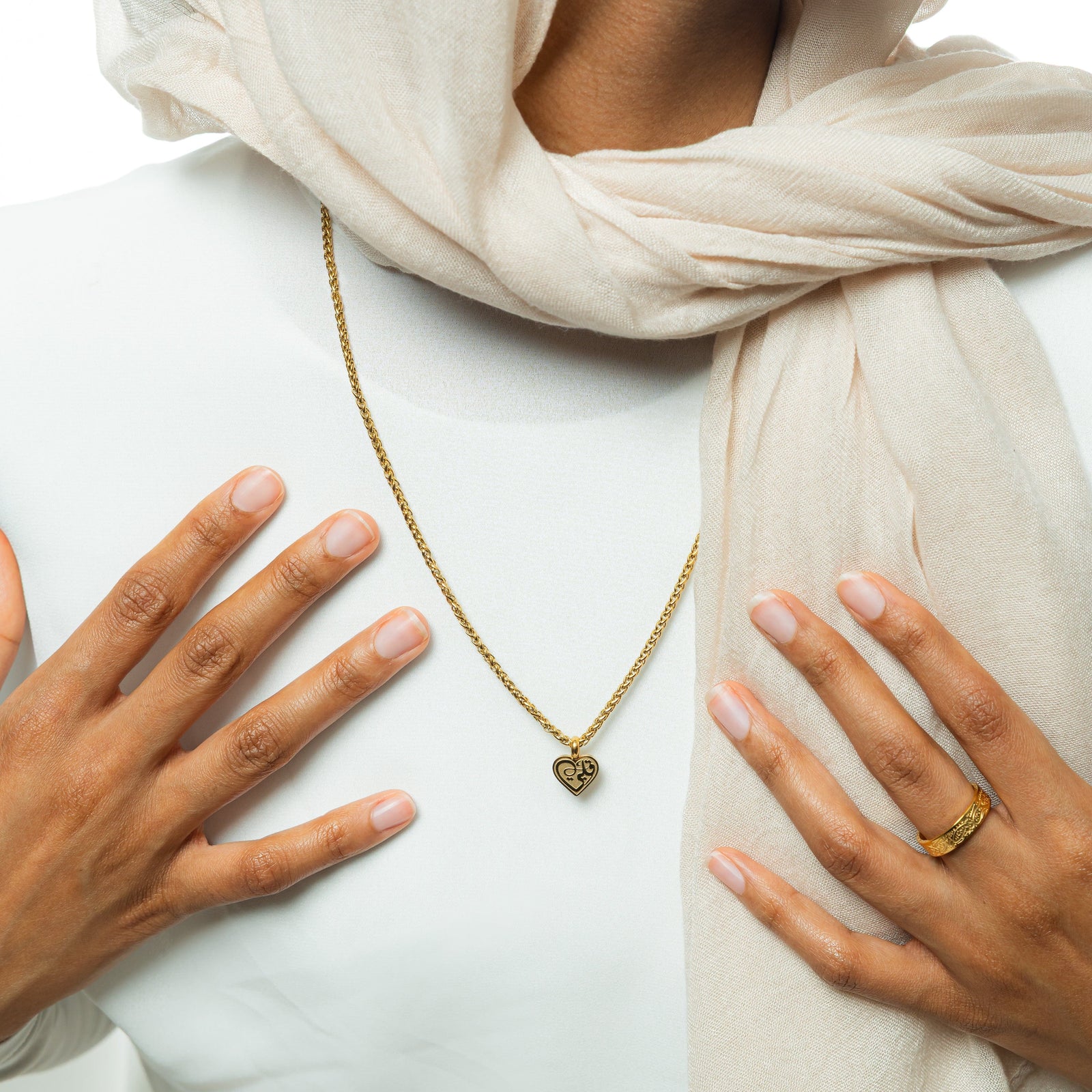 Close up of the gold "Piece of Me" Daughter Necklace as worn by the model.