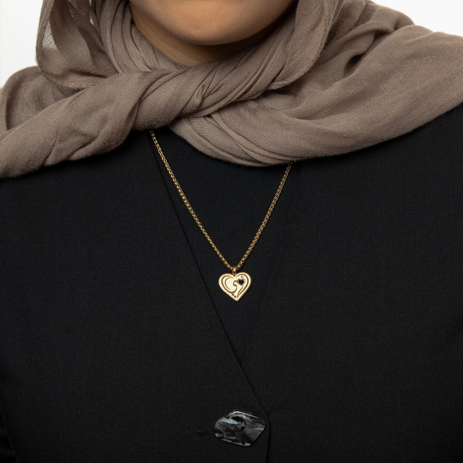 The gold "Piece of Me" Mama Necklace as worn by the model.