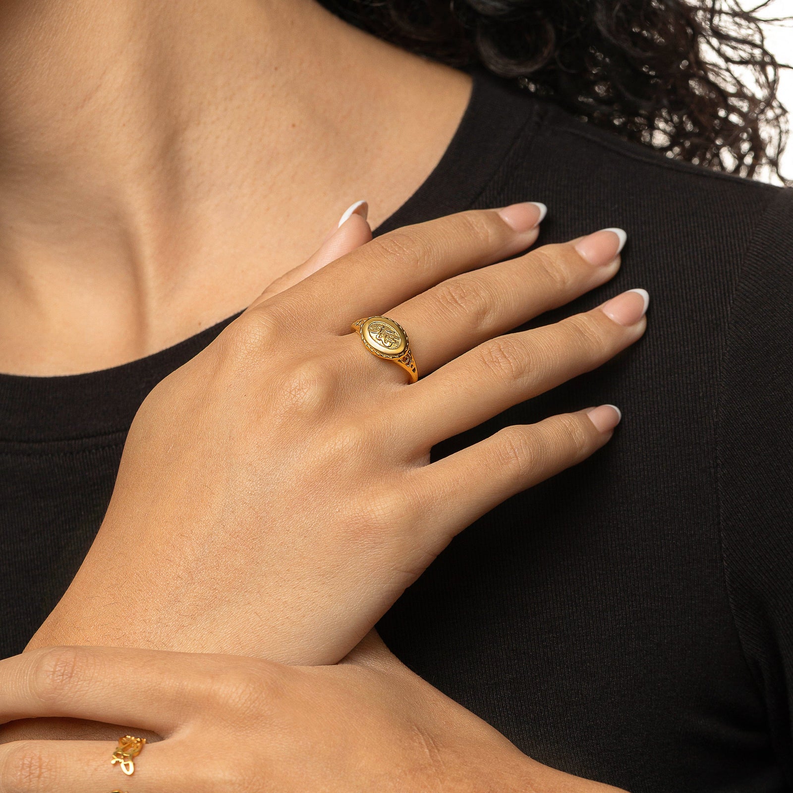 The gold Qadr | Destiny Ring worn on the finger.