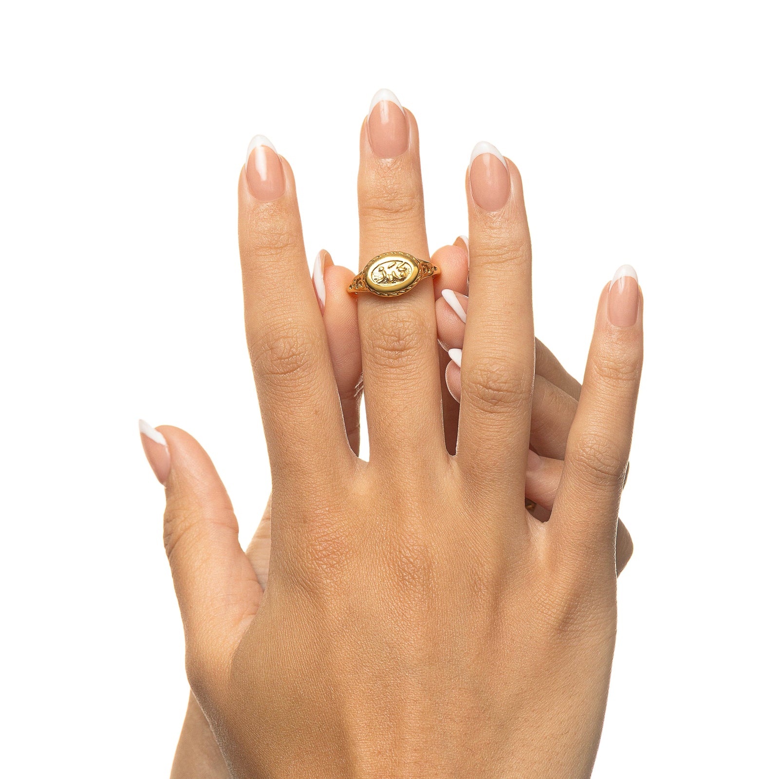 Front-facing view of a hand displaying the gold Qadr | Destiny Ring centered on the finger, highlighting the oval face with Arabic calligraphy.