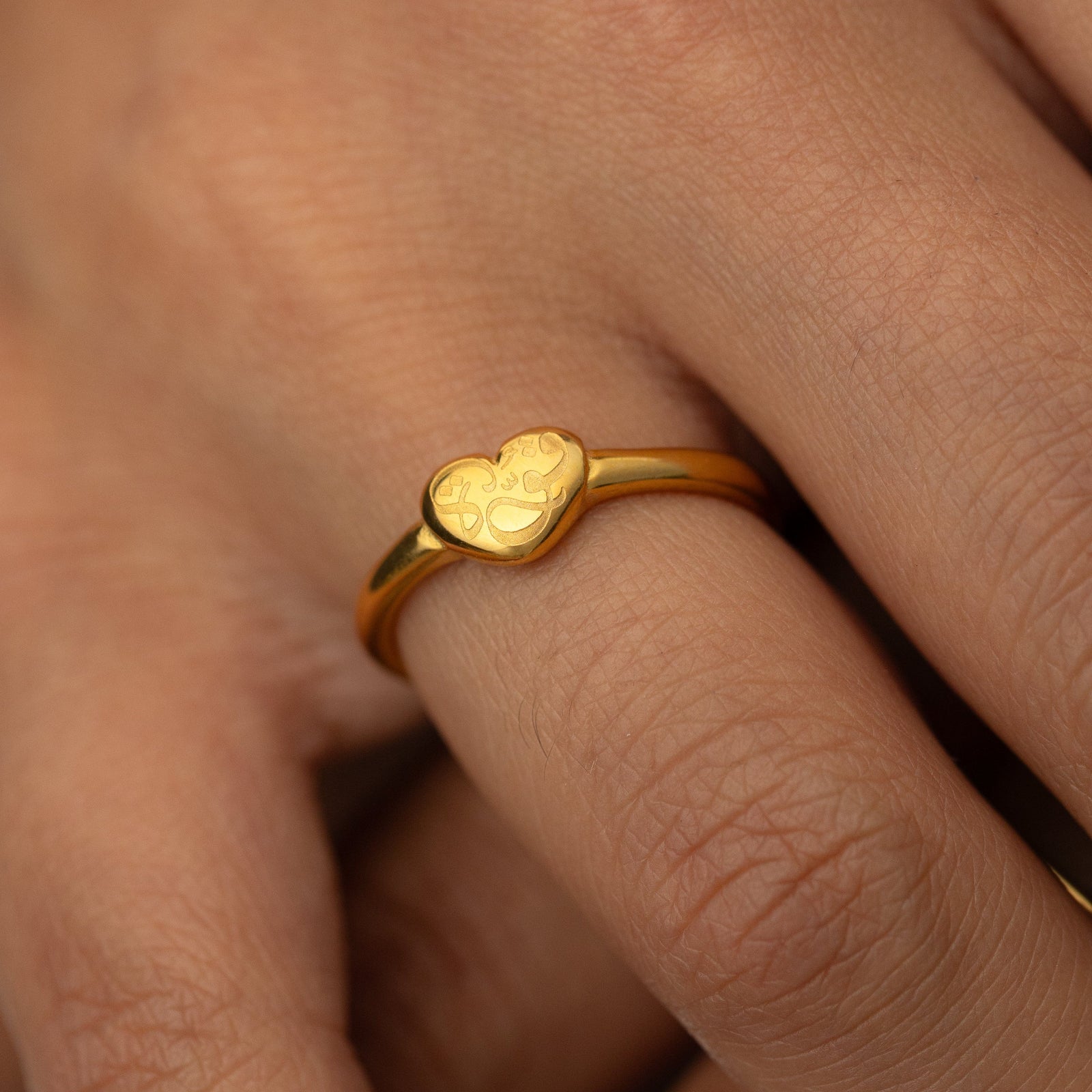 Gold Quwa | Strength Heart ring on a finger