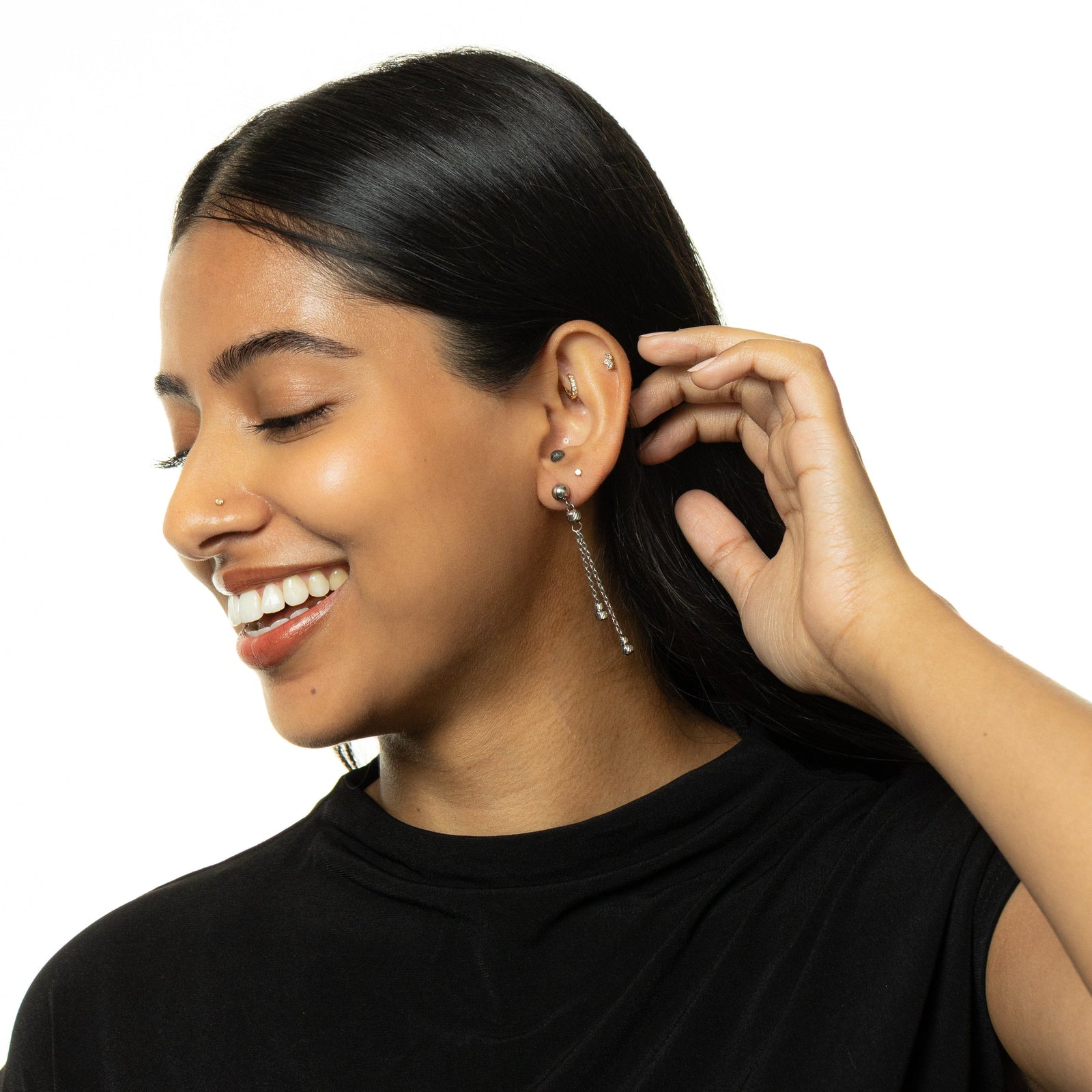 Woman wearing silver Raining Earrings with double chain drops, styled with a black top.