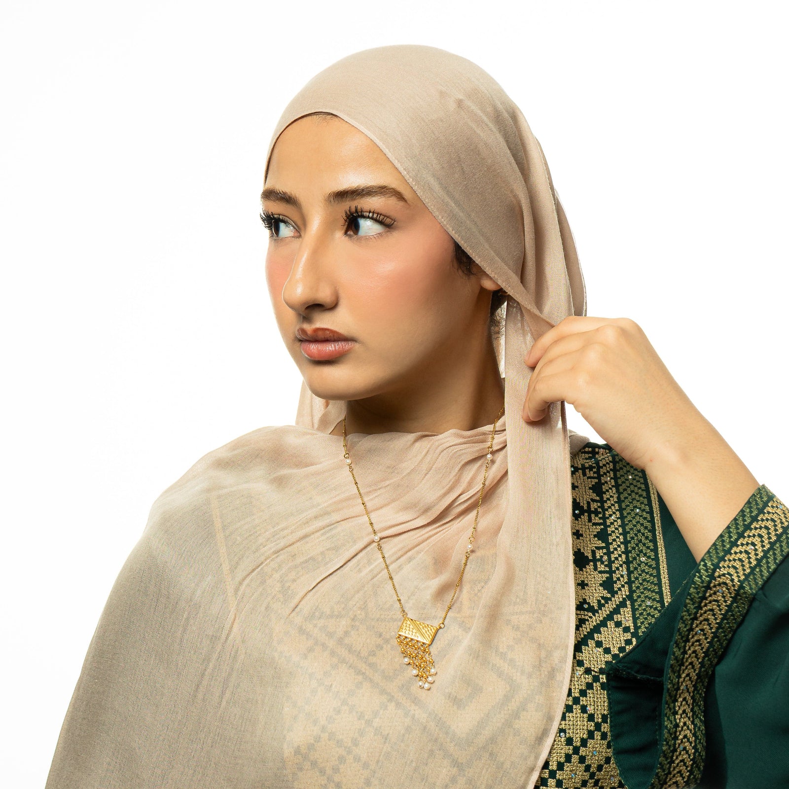 Photo of the model wearing the gold Raining Pearls Keffiyeh Necklace.