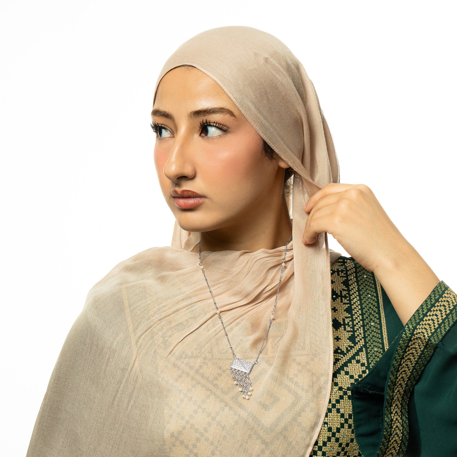 Photo of the model wearing the silver Raining Pearls Keffiyeh Necklace.