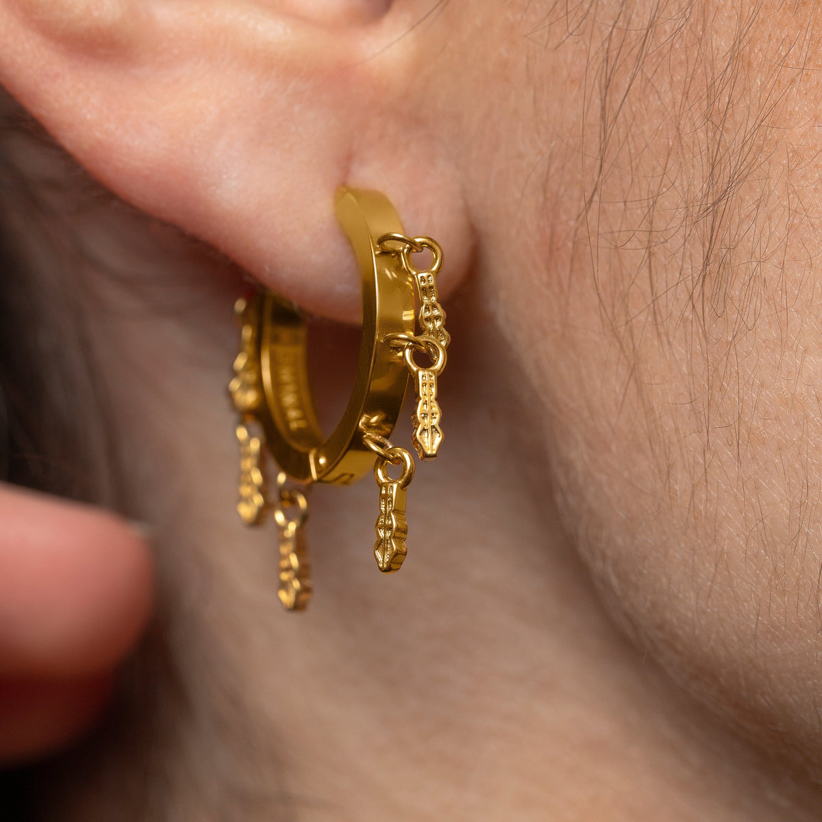 Close up of the gold Raining Tatreez Hoop Earrings
