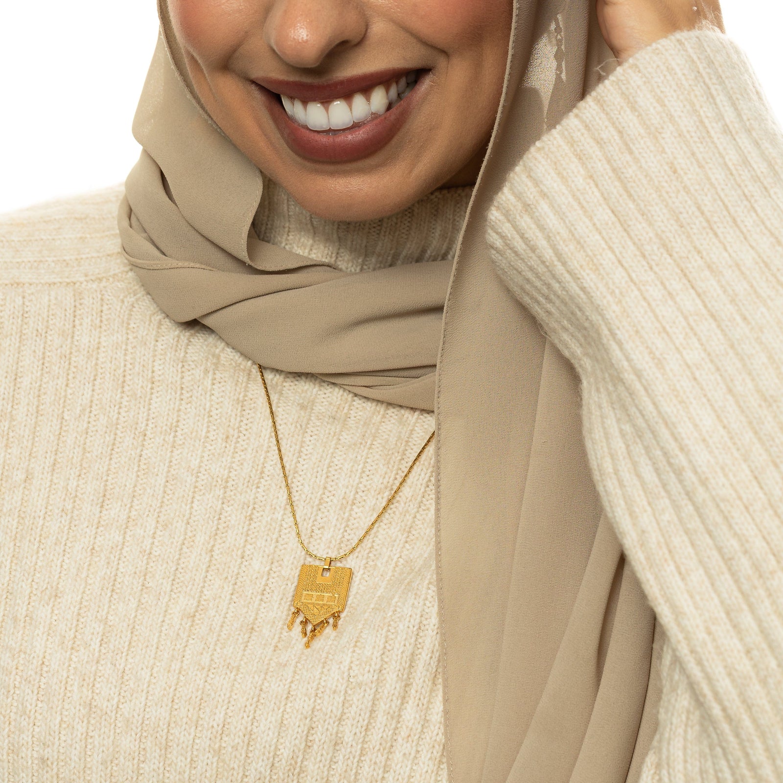 Raining Tatreez Necklace worn over a cream ribbed sweater.
