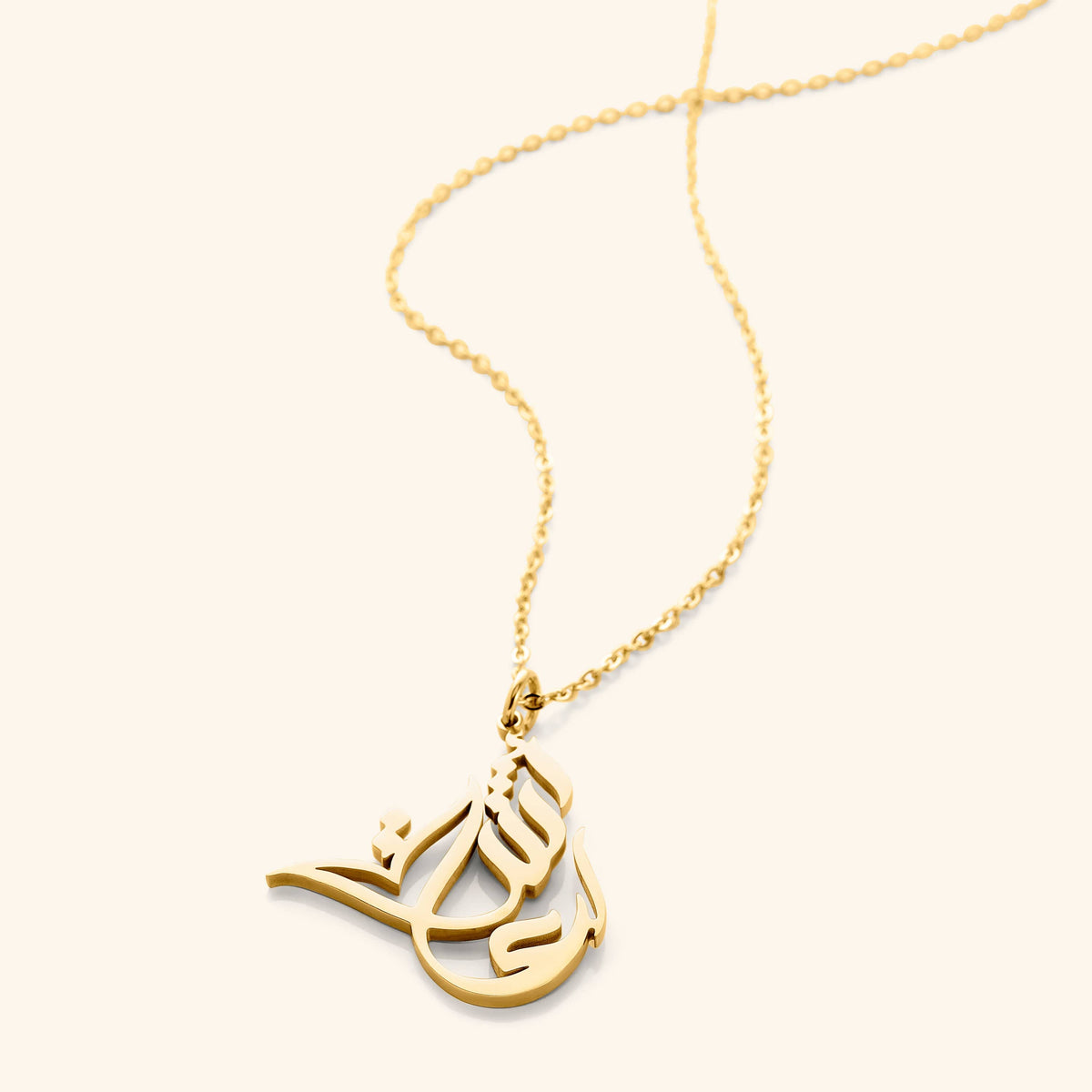 The 18k gold plated Ready Name Necklace | Calligraphy laid flat against a light background.