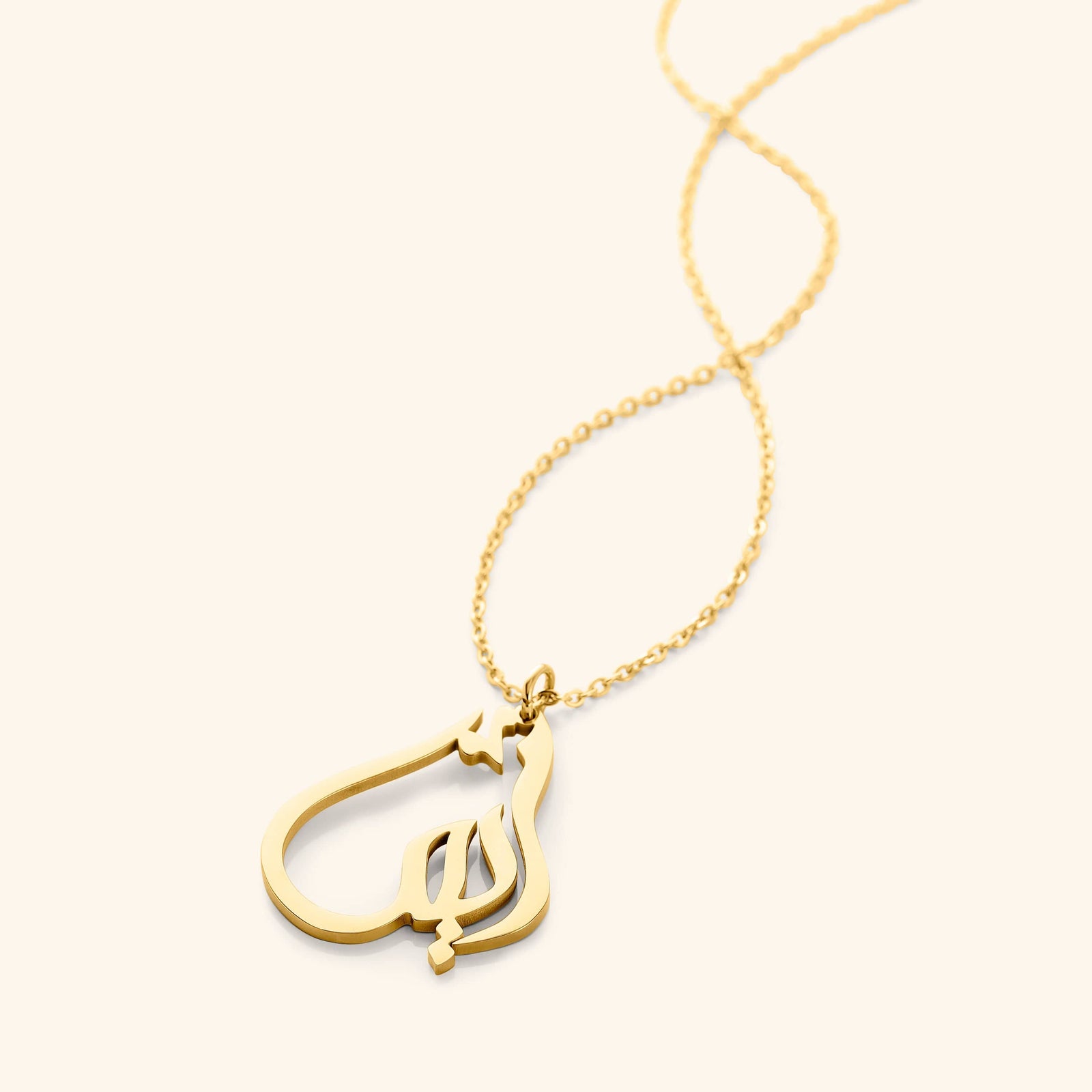 The 18k gold plated Ready Name Necklace | Calligraphy laid flat against a light background.