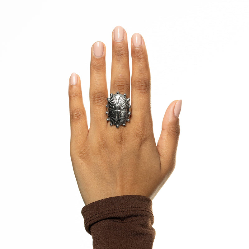 Top view of hand wearing the silver regal garden ring pimage_ fingers extended.