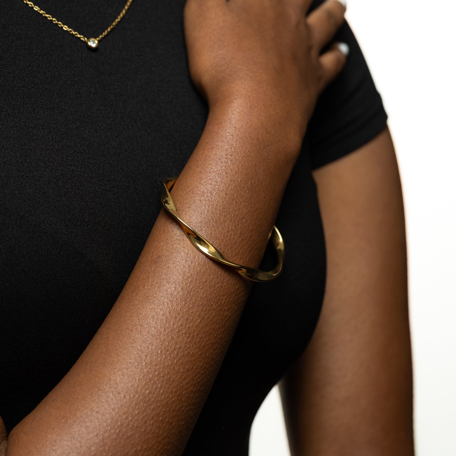 Photo of the model's right hand wearing the Ripple Bangle.