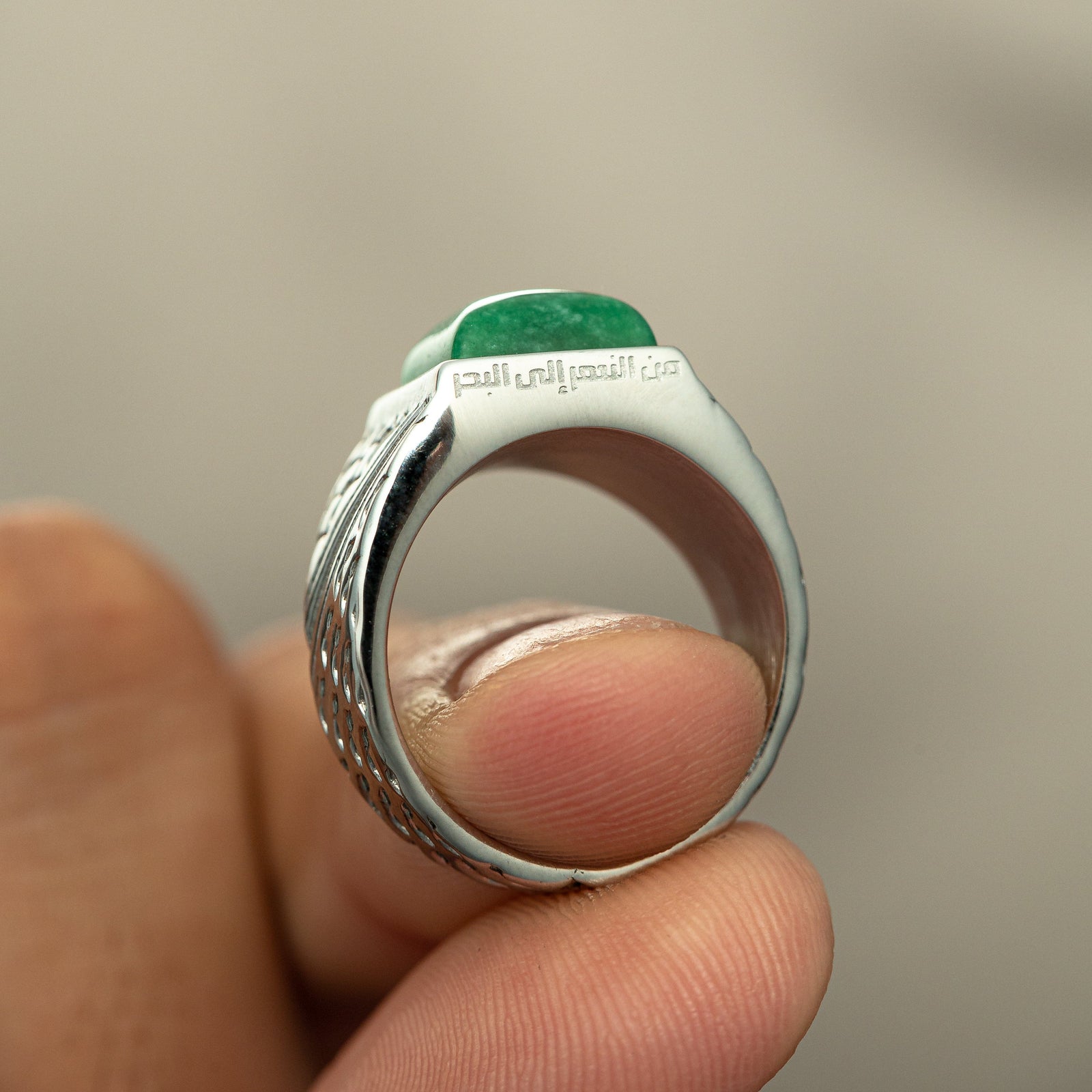 Close-up of the ‘River to Sea’ Onyx Ring | Men showing the Arabic engraving beneath the green onyx stone.