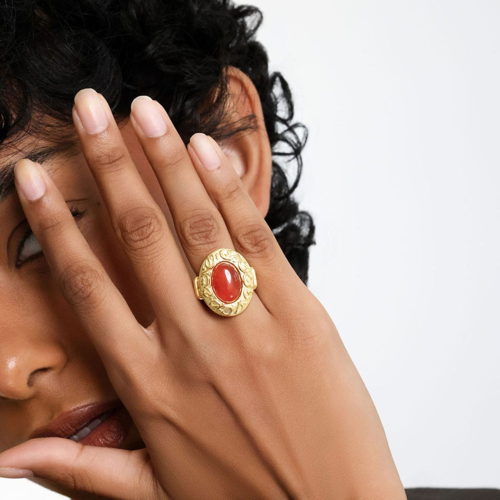Photo of the model with their right hand in front of their face to show the "Roots Don't Fade" Stone Ring they are wearing on their right ring finger.